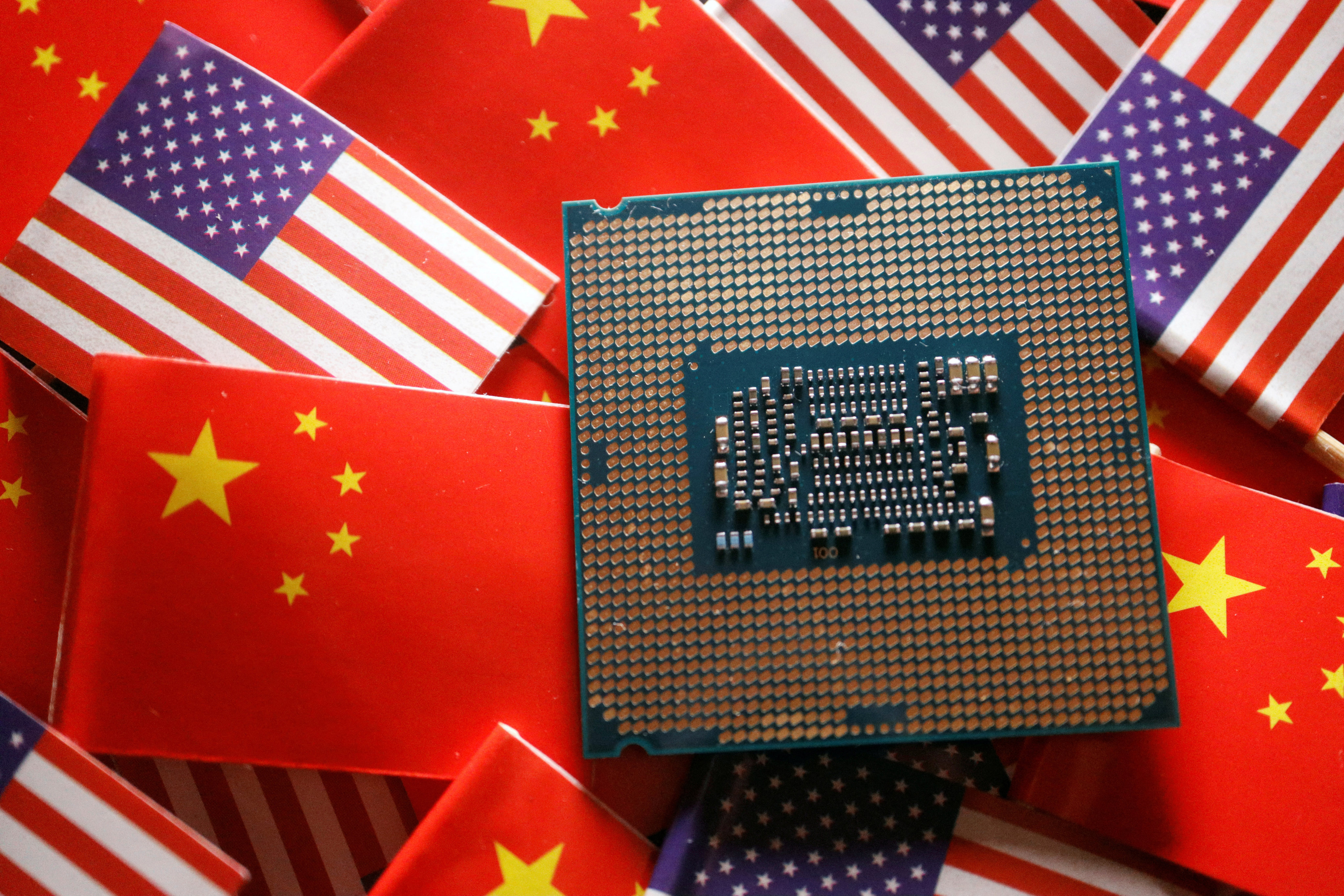 A central processing unit (CPU) semiconductor chip is displayed among China and US flags. Photo: Reuters