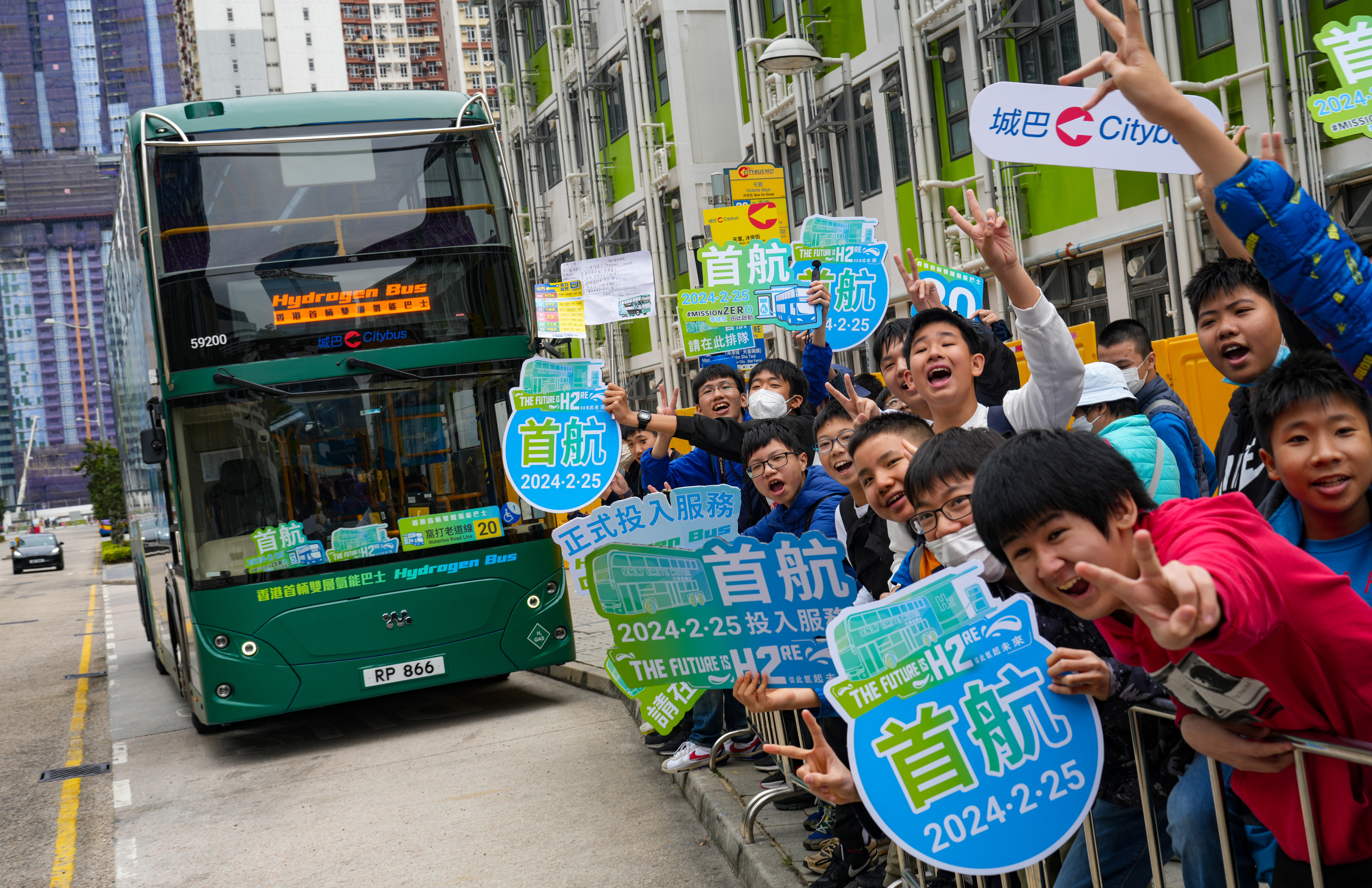 Dozens of bus fanatics, with some queueing hours  in anticipation, cheer on board the maiden voyage of Hong Kong’s first hydrogen-powered double-deck bus. Photo: Sam Tsang