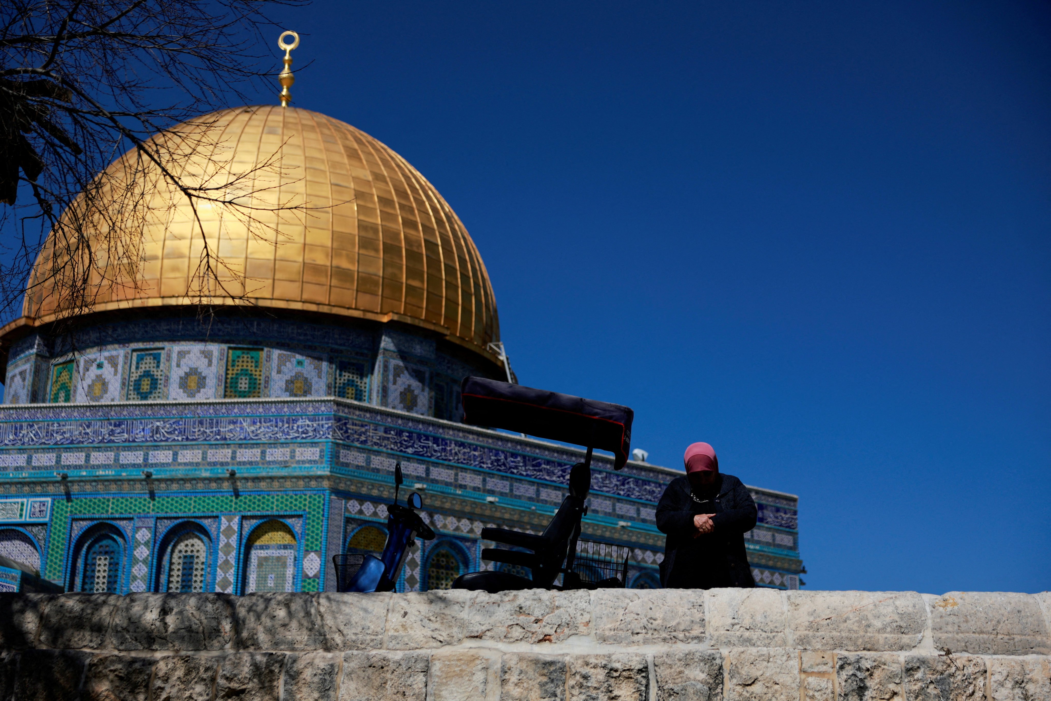 A Palestinian woman prays at the Al-Aqsa compound in Jerusalem’s Old City on Tuesday. Photo: Reuters