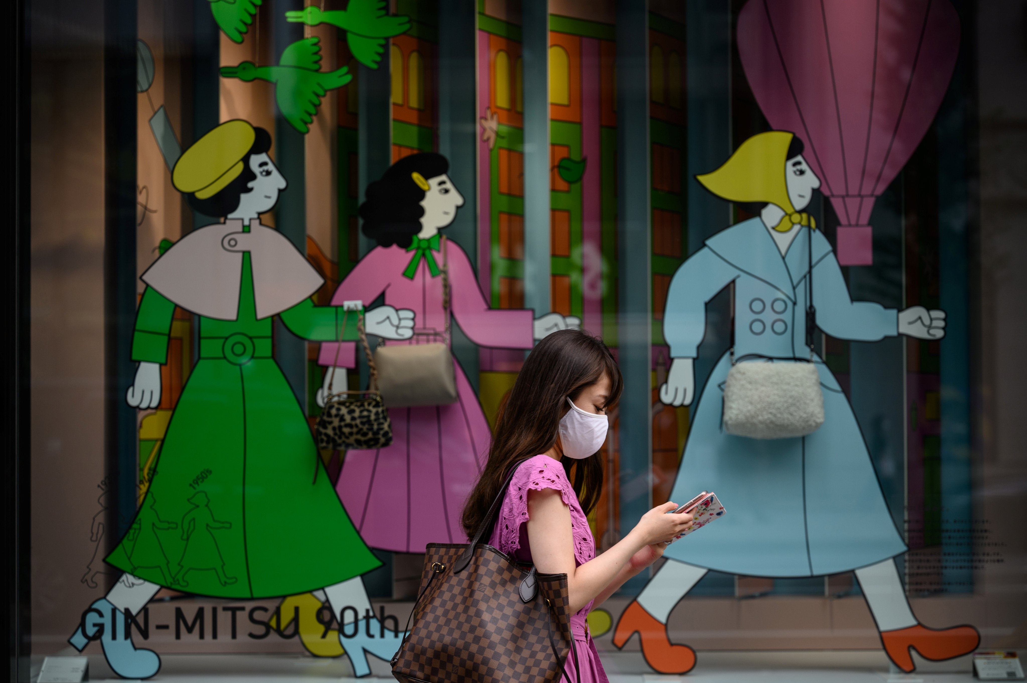 A woman walks past a mural in Tokyo. Japan has the most pronounced gender gap among the OECD countries, a World Bank study has shown. Photo: AFP via Getty Images