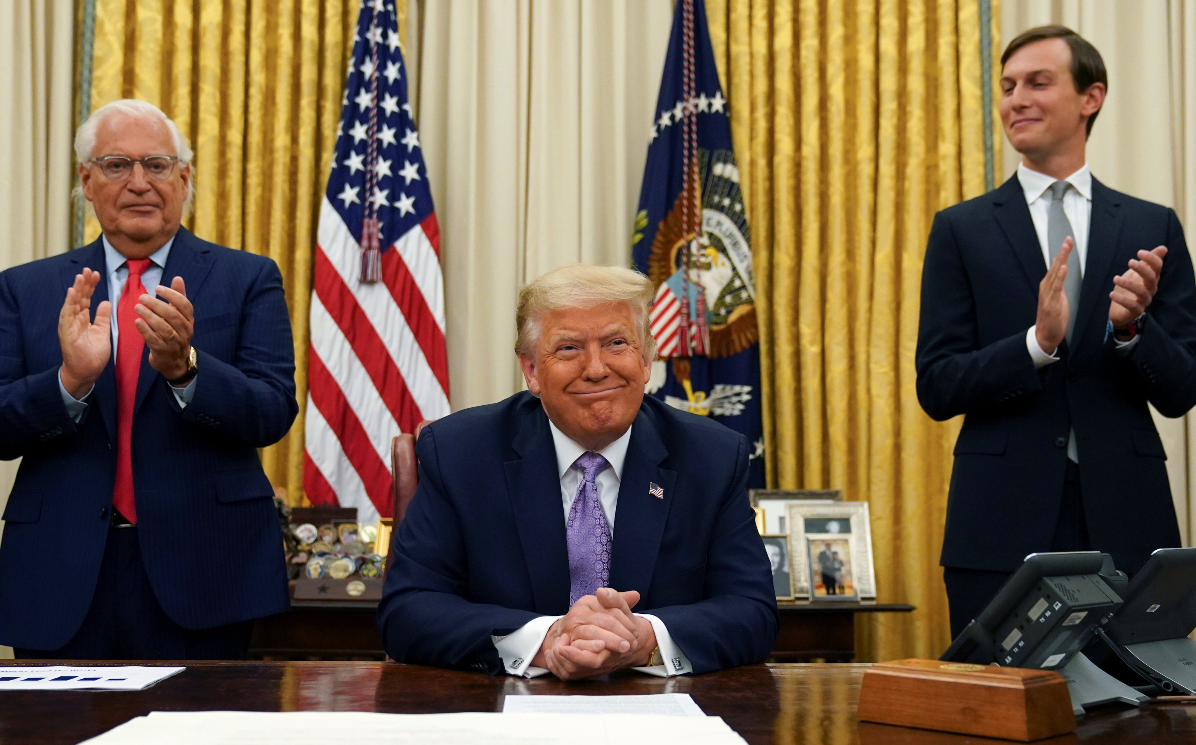 Then president Donald Trump is applauded by his ambassador to Israel David Friedman and White House senior adviser Jared Kushner on August 13, 2020. Photo: Reuters