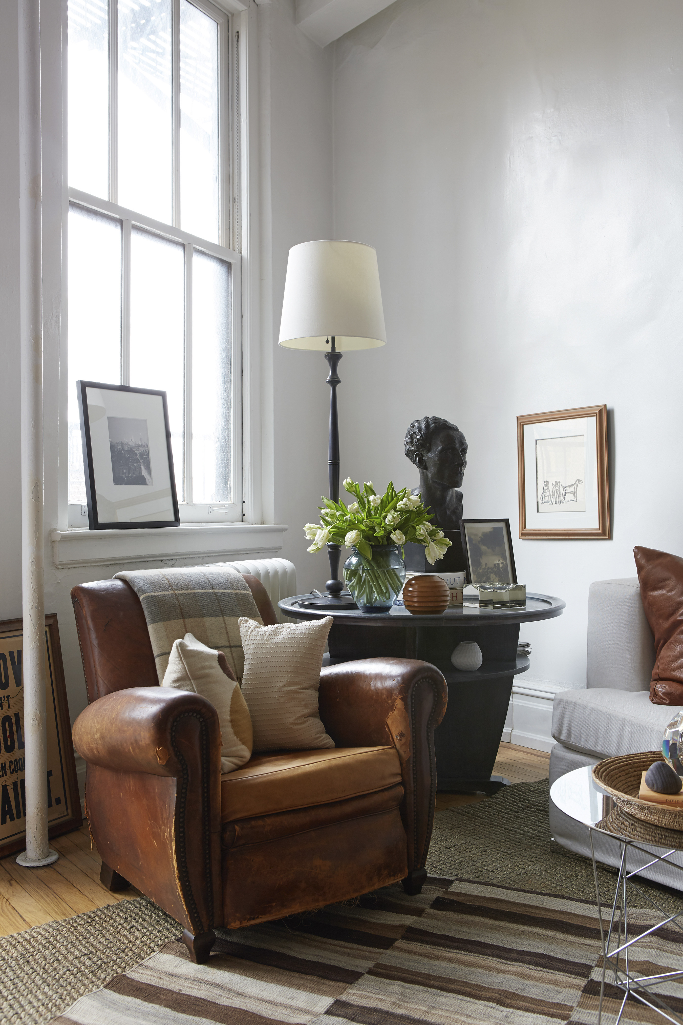 A vintage leather armchair and two-tiered table take pride of place in a living room. Designer Dan Mazzarini says such “slow decorating” includes an appreciation for high-quality and sustainable vintage pieces. The home trend is seen as fighting back against fast furniture brands like Ikea. Photo: AP