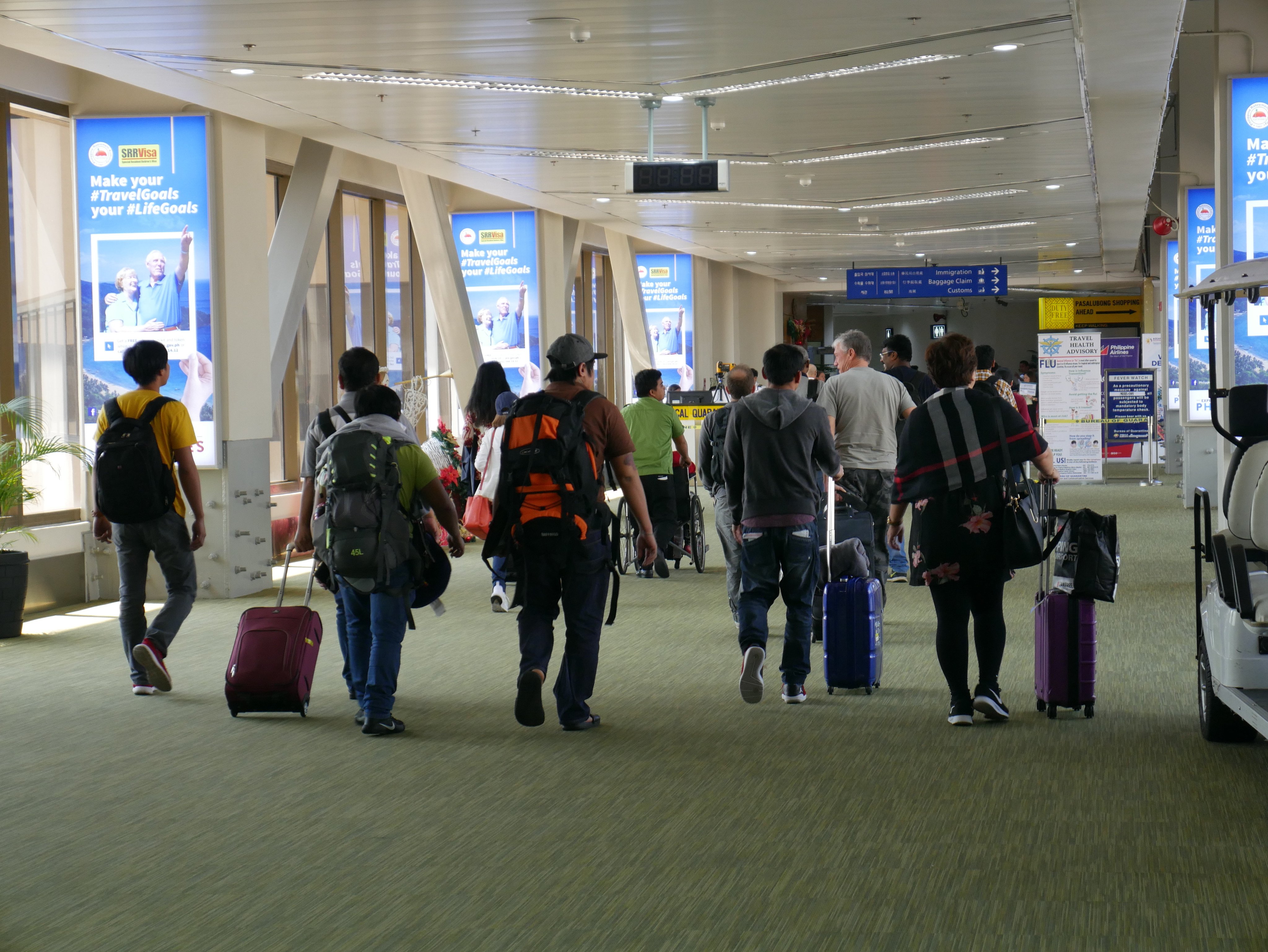 Travellers at Manila’s Ninoy Aquino International Airport. The Bureau of Immigration said a whole-of-government response was required to tackle the threat from foreigners entering the country using valid documents obtained through illicit ways. Photo: Shutterstock