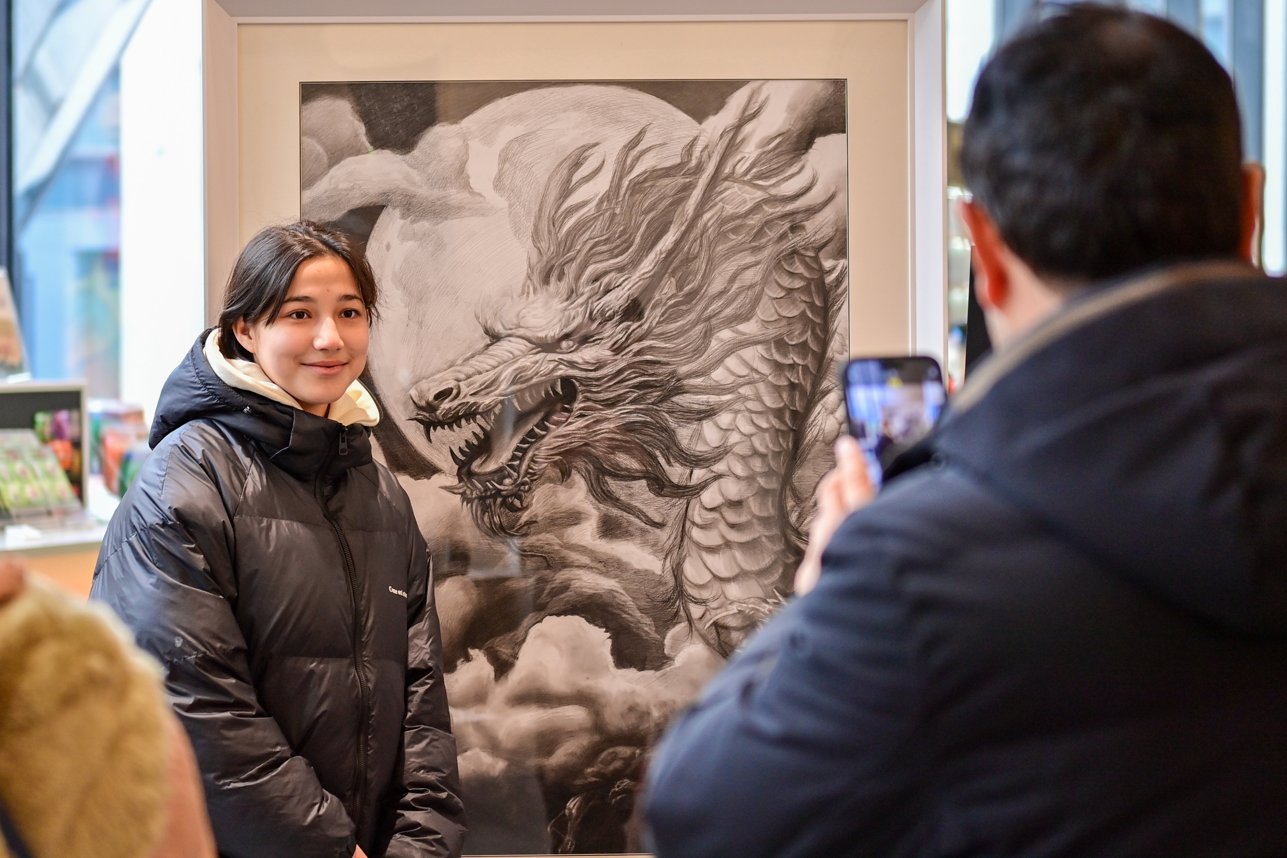 A visitor poses with an exhibit at a museum in Urumqi, capital of the Xinjiang Uygur autonomous region, on February 14. A US panel on China has asked the State Department to raise the risk level of its Xinjiang travel advisory to dissuade tourism there. Photo: Xinhua