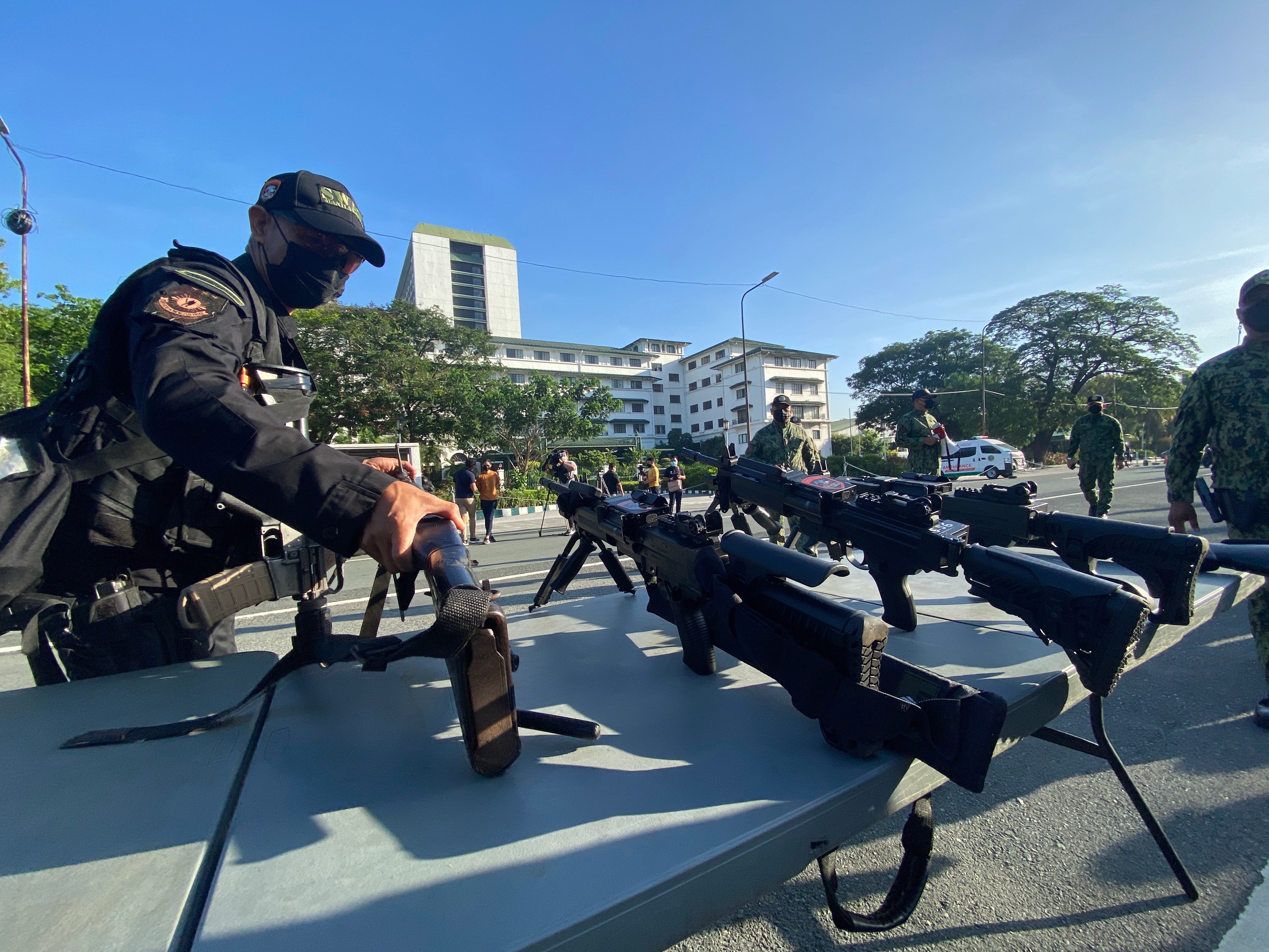 A Filipino elite Police Special Weapons and Tactical personnel inspects firearms during deployment in Manila. Photo: EPA-EFE