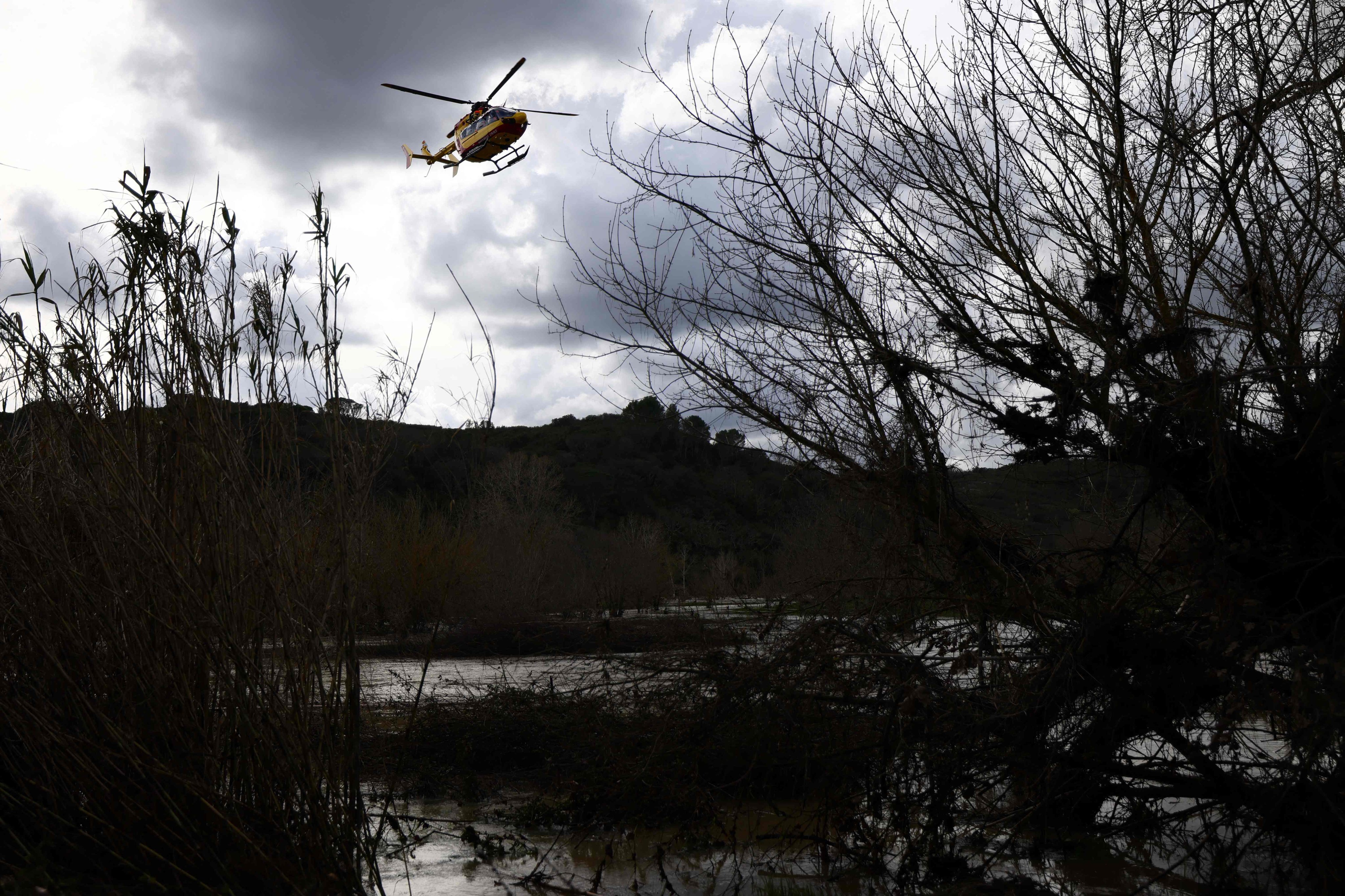 A helicopter in France takes part in search operations on Sunday for seven people missing after floods. Photo: AFP