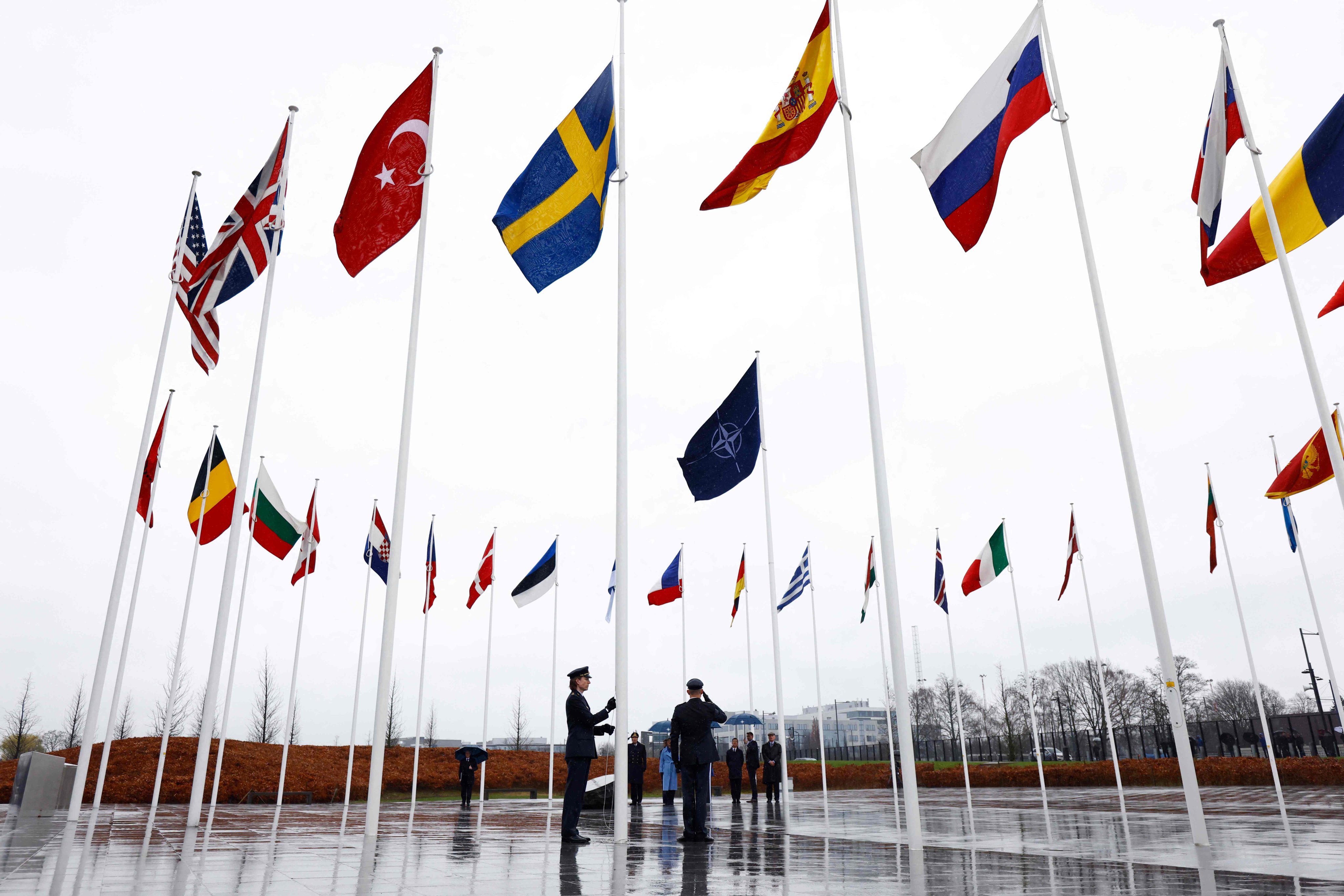 Officials hoist the Swedish national flag on a pole during a flag raising ceremony for Sweden’s accession to Nato at the alliance’s headquarters in Brussels. Photo: AFP