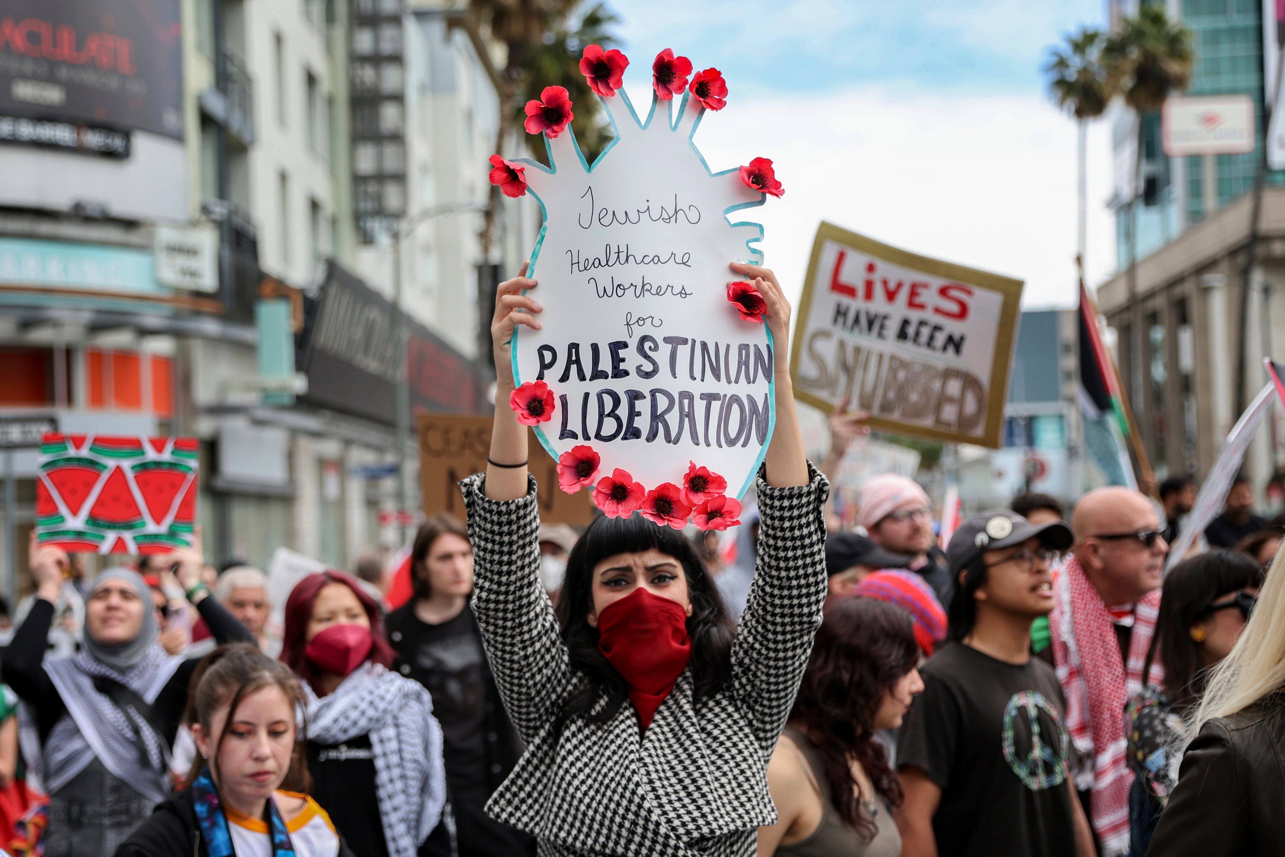 A protester in Hollywood, Los Angeles on Sunday holds a poster during a demonstration calling for a ceasefire in Gaza as the Oscars ceremony is held nearby. Photo: AP