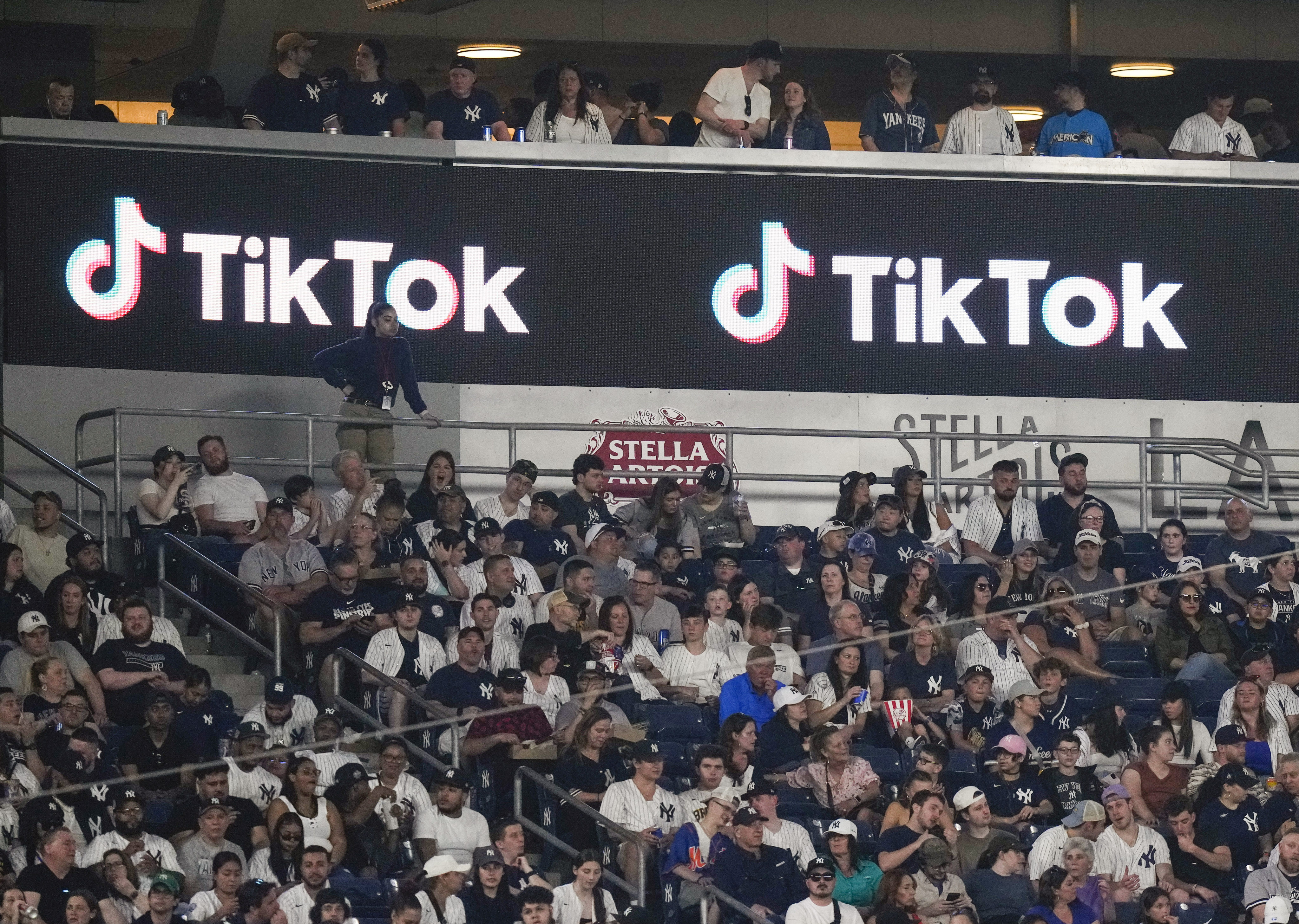 Fans sit under a TikTok ad at a baseball game at Yankee Stadium on April 14, 2023. Photo: AP