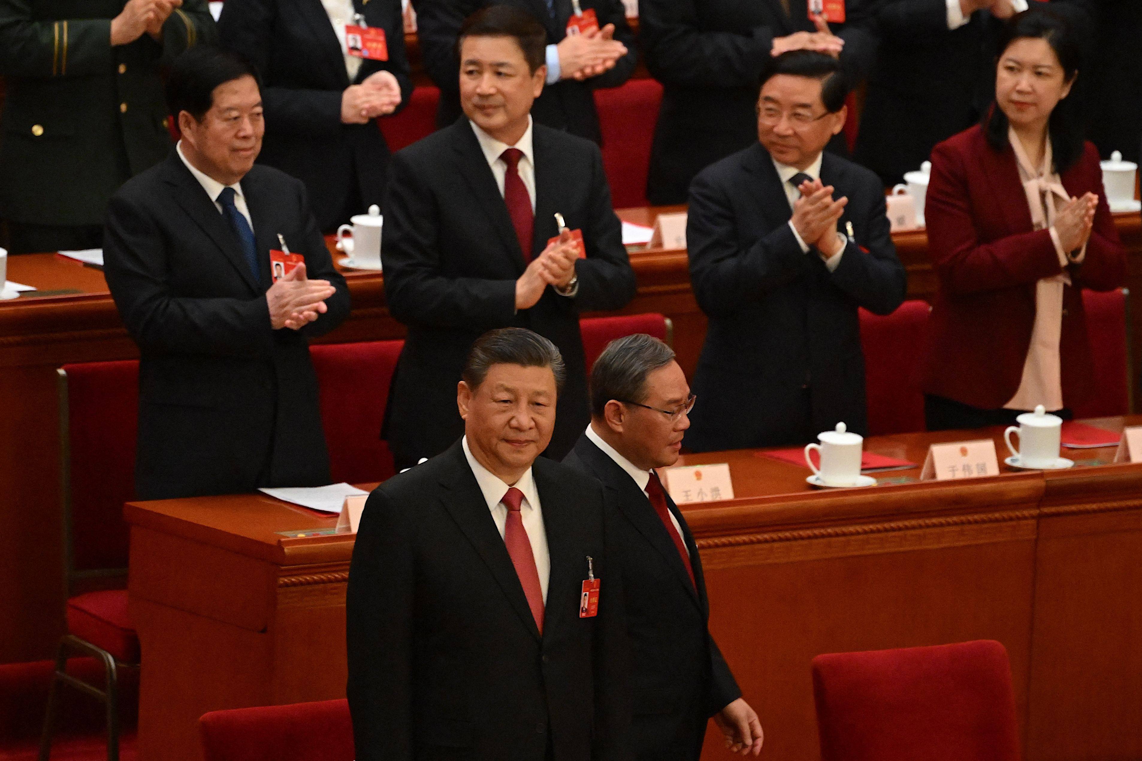 President Xi Jinping (front row, left) and Premier Li Qiang (front row, right) arrive for the closing session of the 14th National People’s Congress at the Great Hall of the People in Beijing on March 11. Photo: AFP