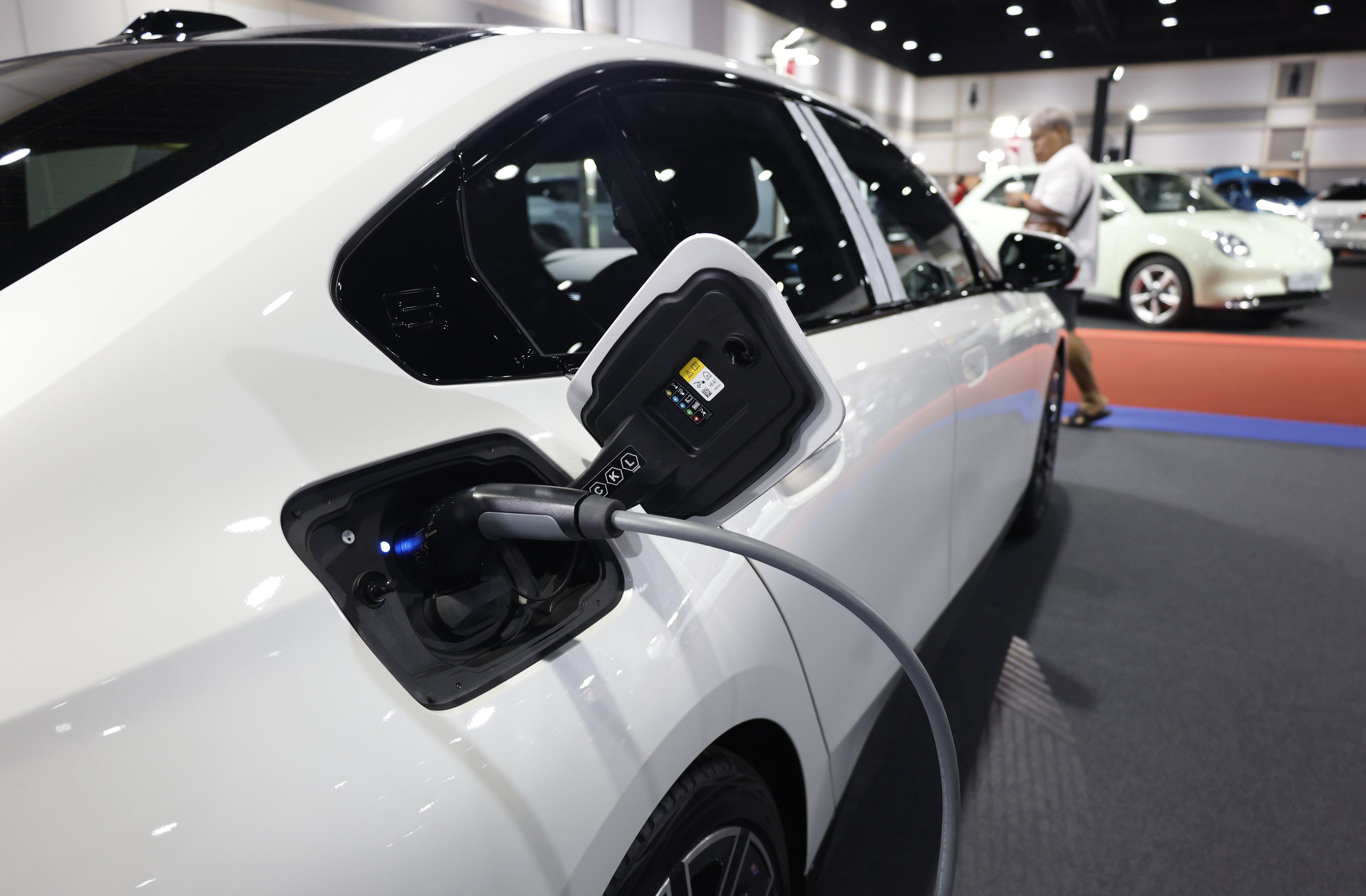 An electric vehicle (EV) being charged while on display at the Bangkok EV Expo 2024 on February 11, 2024. Photo: EPA-EFE