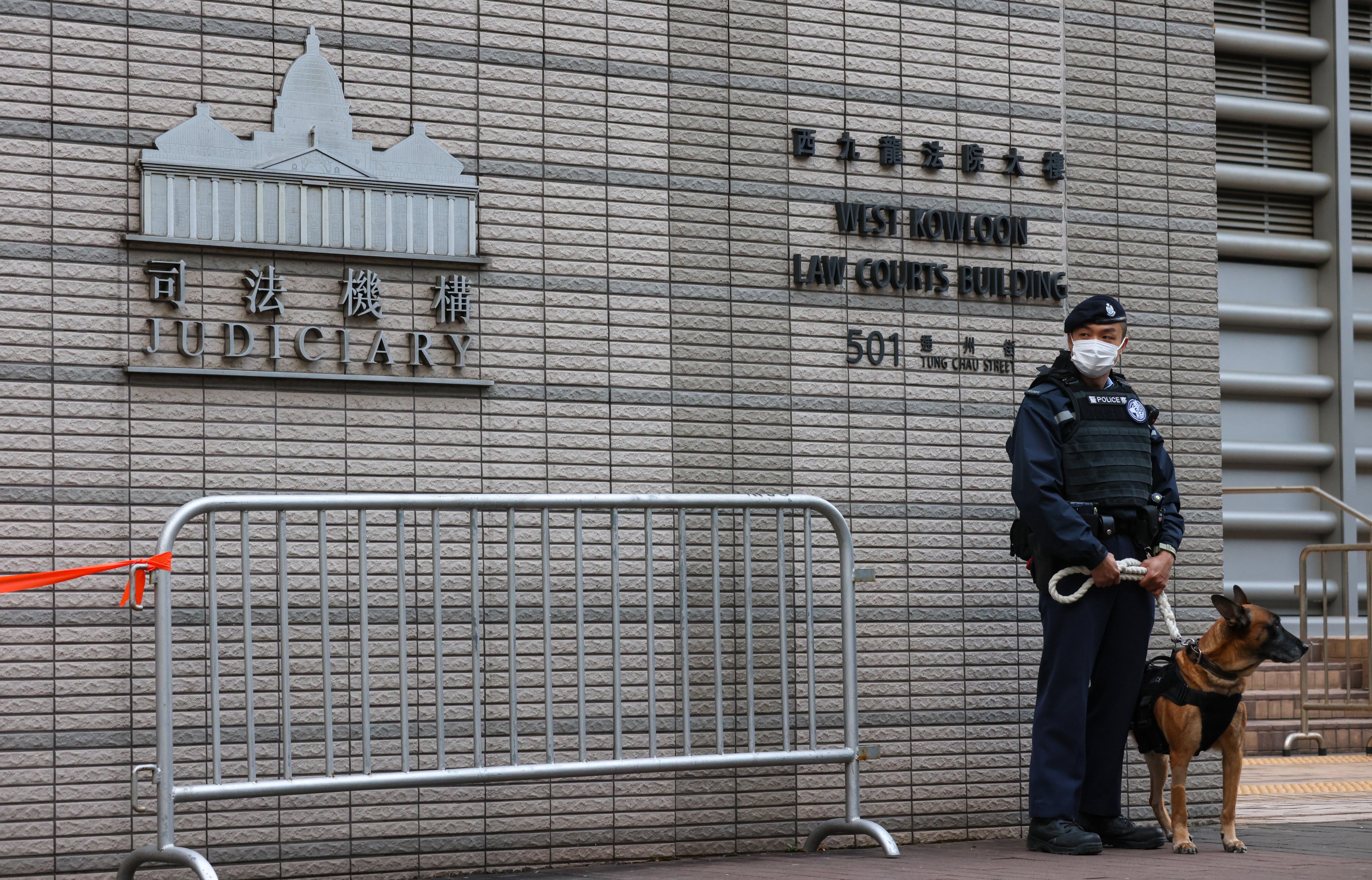 A police officer stands guard outside West Kowloon Court during Jimmy Lai’s national security trial. Photo: Yik Yeung-man
