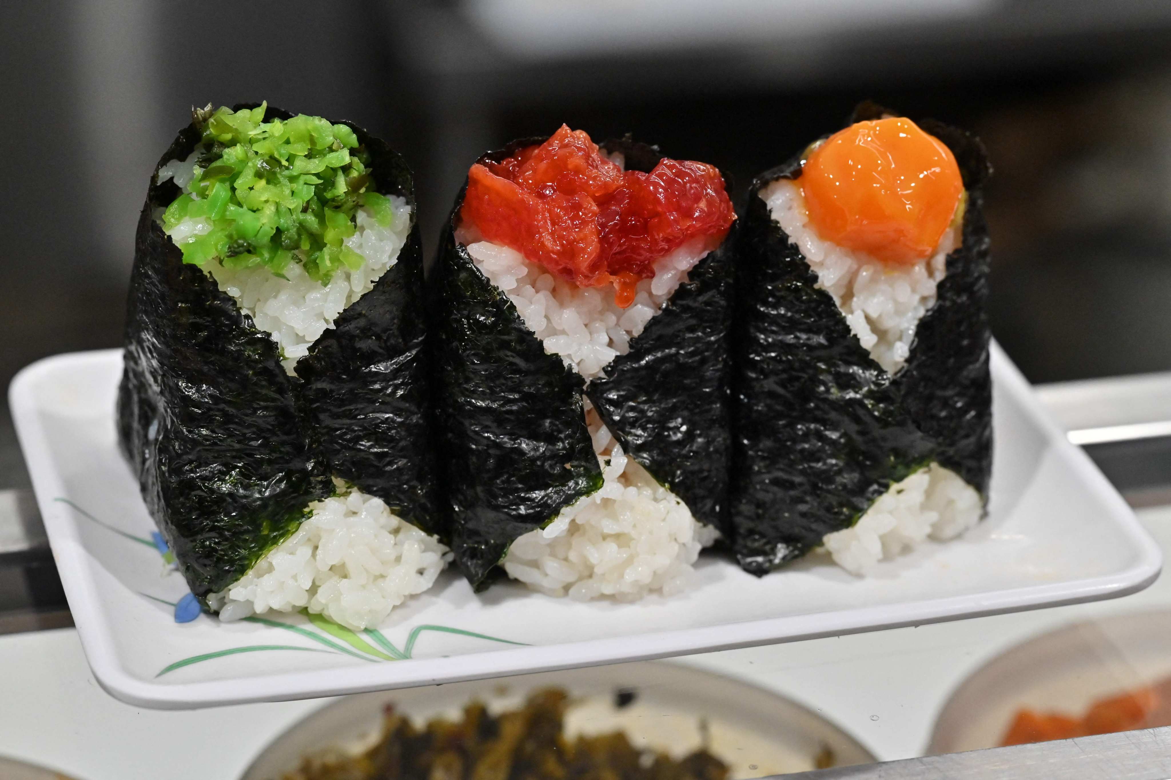 Wrapped in seaweed and stuffed with delicious fillings, onigiri rice balls are shaking off their reputation as a cheap and uninspiring snack in Japan. Photo: AFP