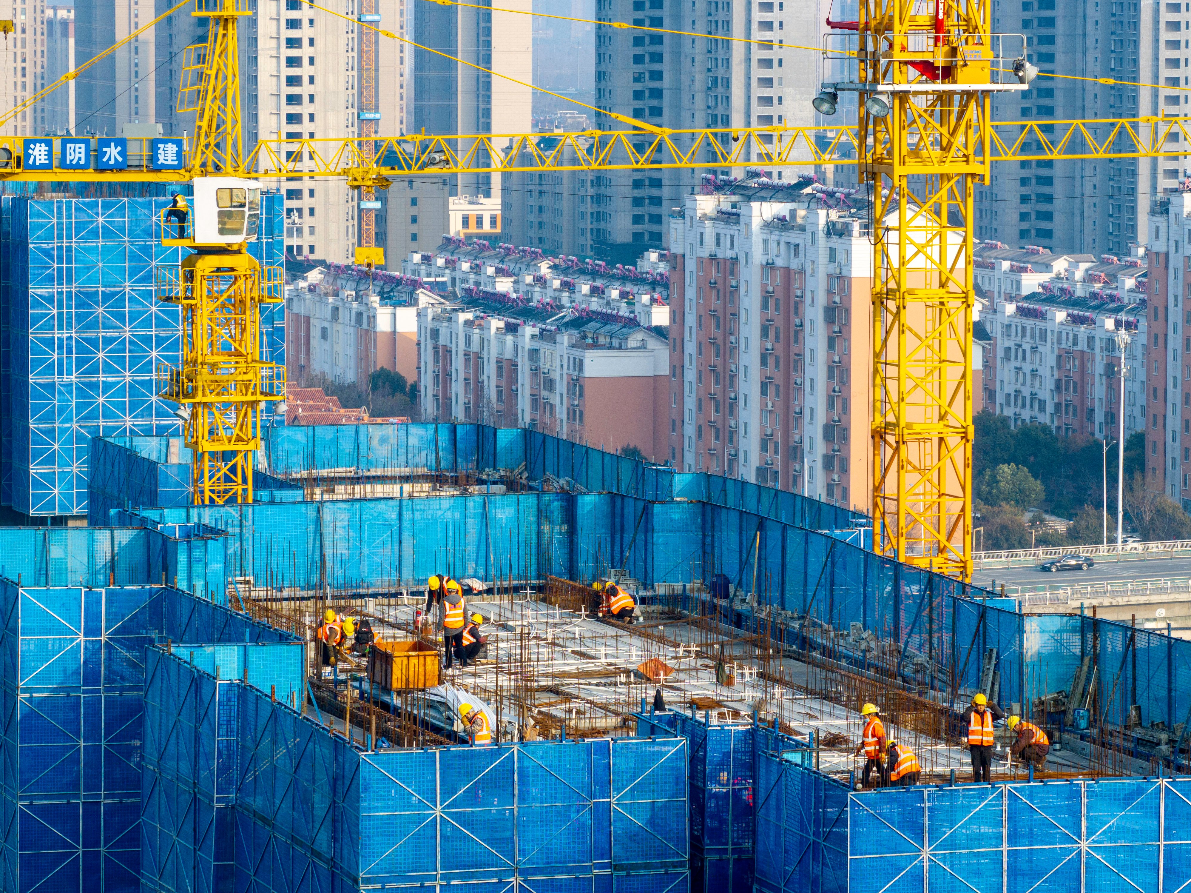 Workers at a construction site of a housing project along the Beijing-Hangzhou Grand Canal on March 2, 2024. Photo: Getty Images