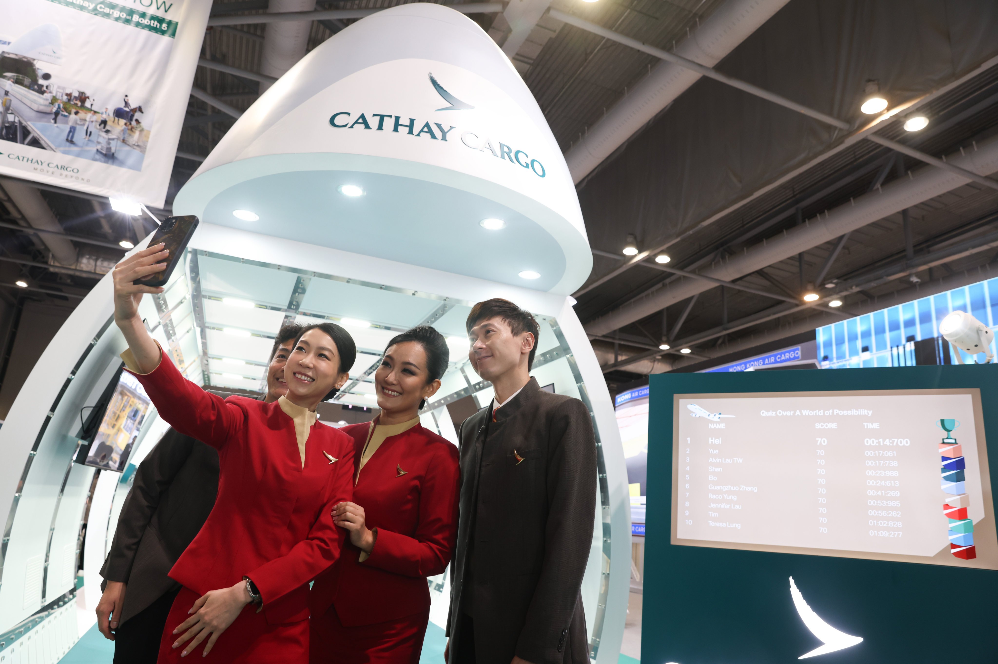 Cathay Pacific flight attendants take a selfie at the airline’s booth during the IATA World Cargo Symposium at AsiaWorld-Expo on March 12. Photo: Yik Yeung-man