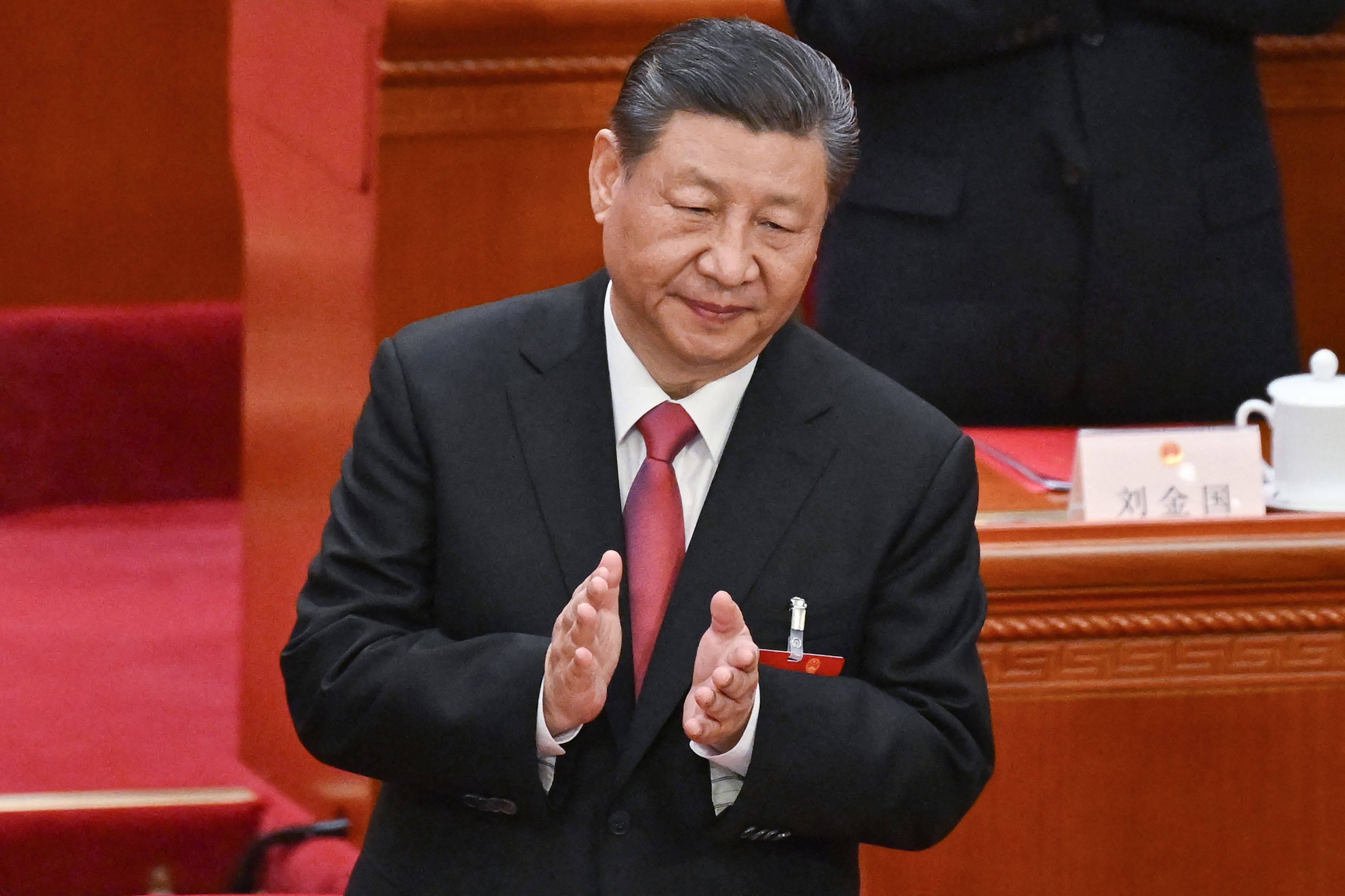 China’s President Xi Jinping applauds at the end of the closing session of the 14th National People’s Congress at the Great Hall of the People in Beijing on March 11. Photo: AFP