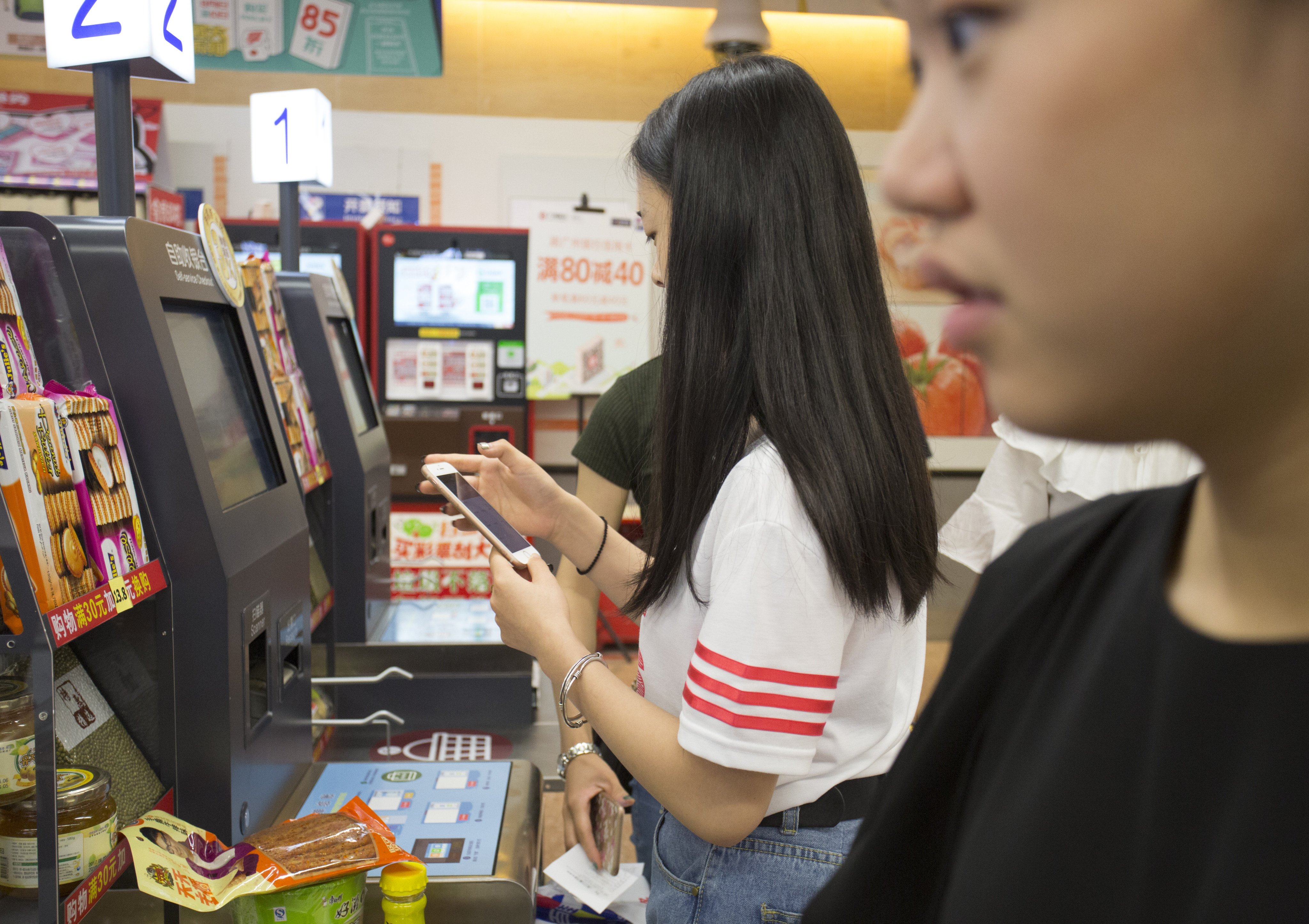 Customers use their mobile phones to make a payment at a ParkNShop store in Shenzhen in August 2017. Photo: May Tse     