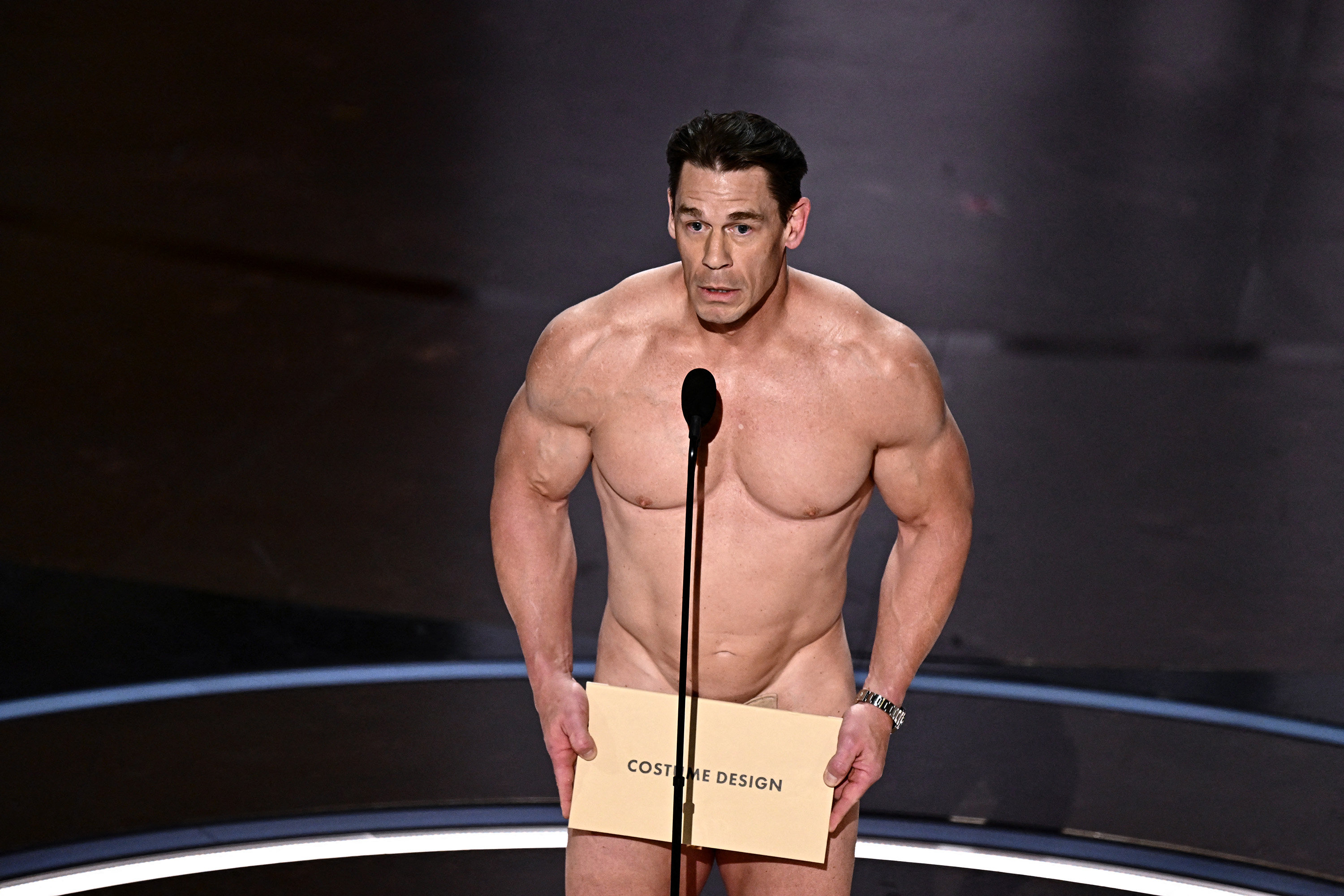 John Cena presents the award for best costume design onstage during the 96th Academy Awards at the Dolby Theatre in Hollywood, California, on Sunday, March 10, 2024. (Patrick T. Fallon/AFP/Getty Images/TNS)