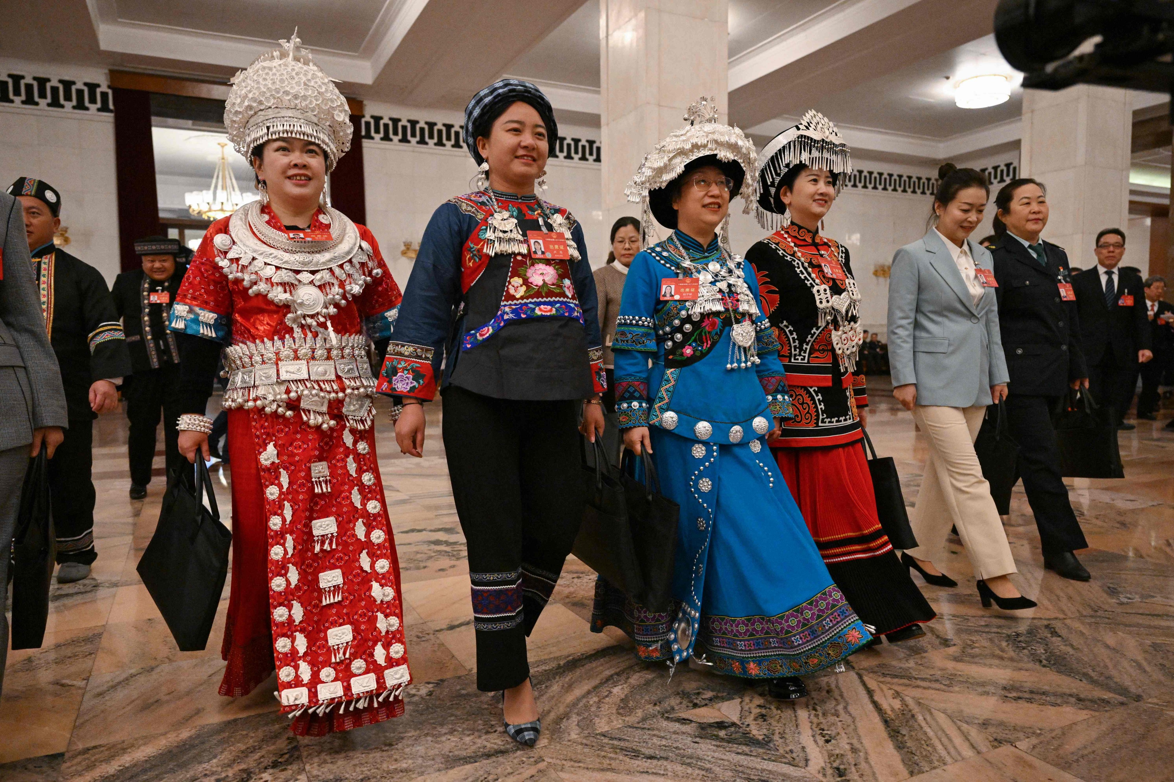Deputies from ethnic minority groups arrive for the NPC opening session on March 5, 2024. Photo: AFP