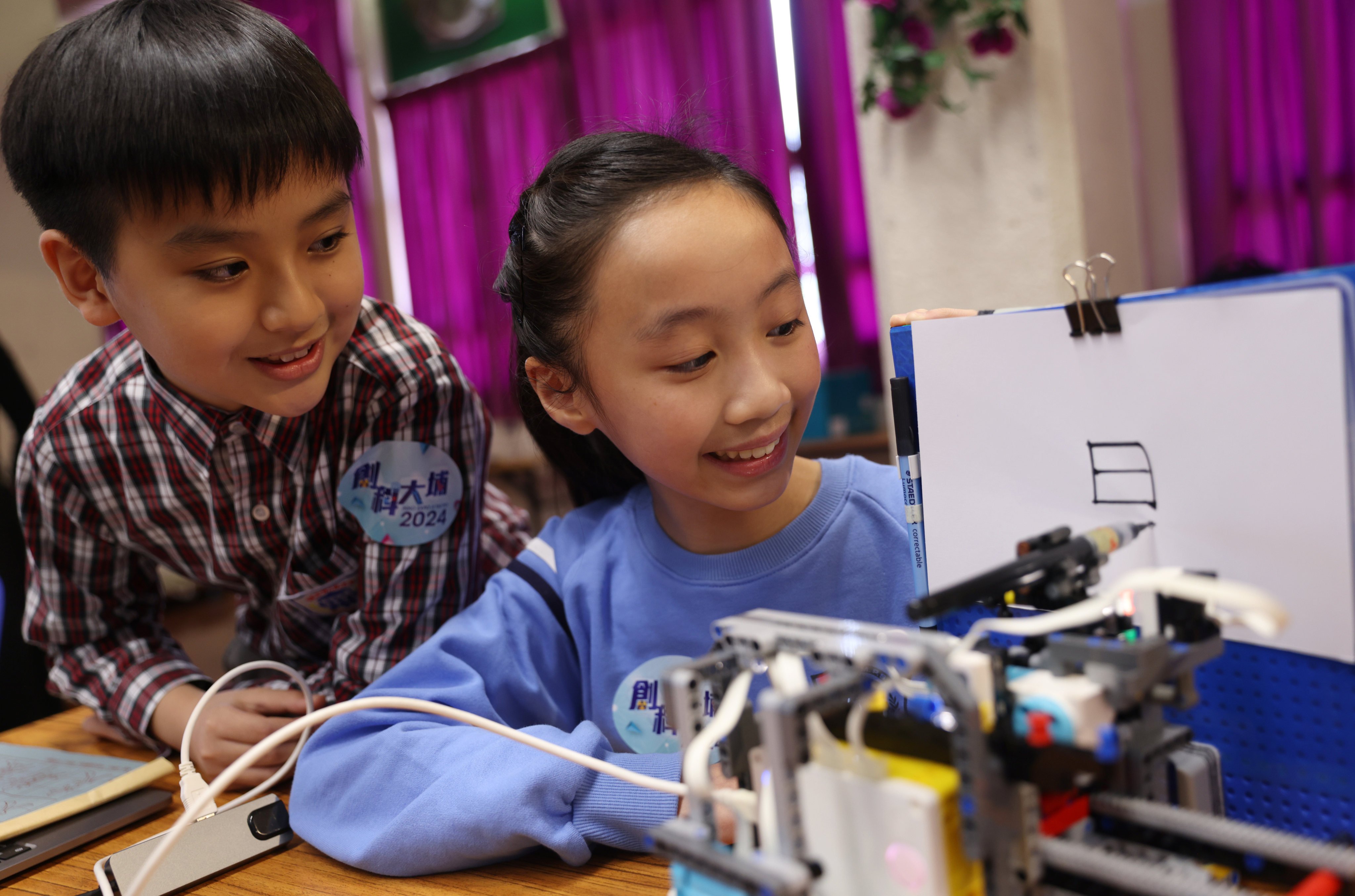 Two primary school students in Hong Kong show their invention at an expo that showcases the technological innovations by student inventors, on January 16 in Hong Kong’s Tai Po district. Photo: Yik Yeung-man