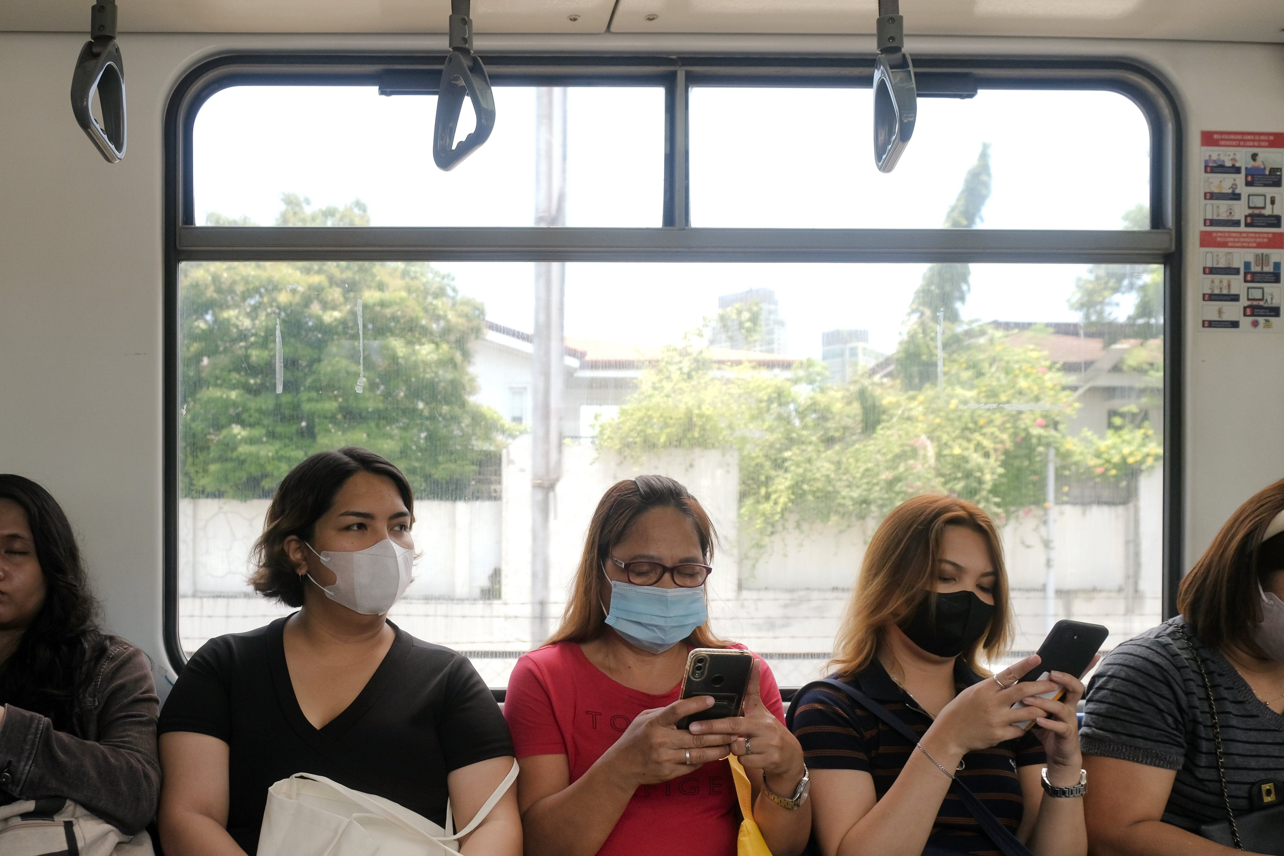 Commuters use their phones in an LRT train in Manila. Photo: Shutterstock