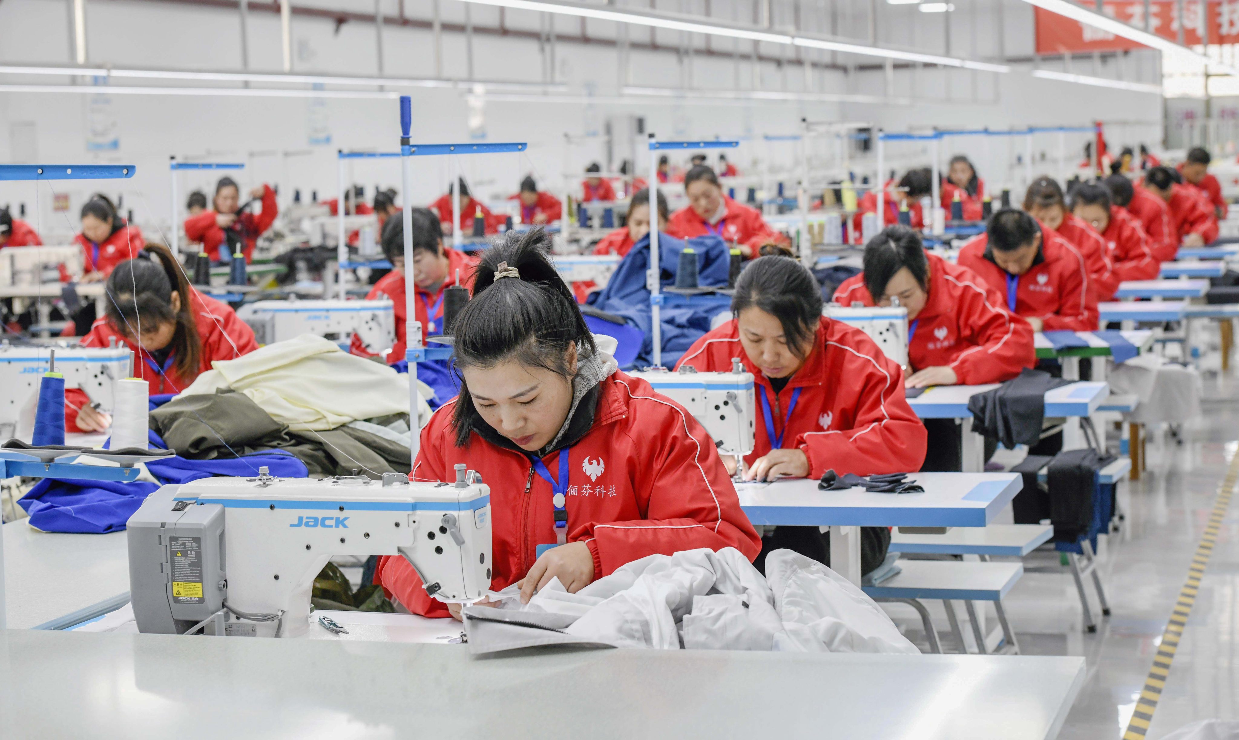 Workers sew at a workshop of a garment company in Zunhua, north China’s Hebei Province. Photo: Xinhua
