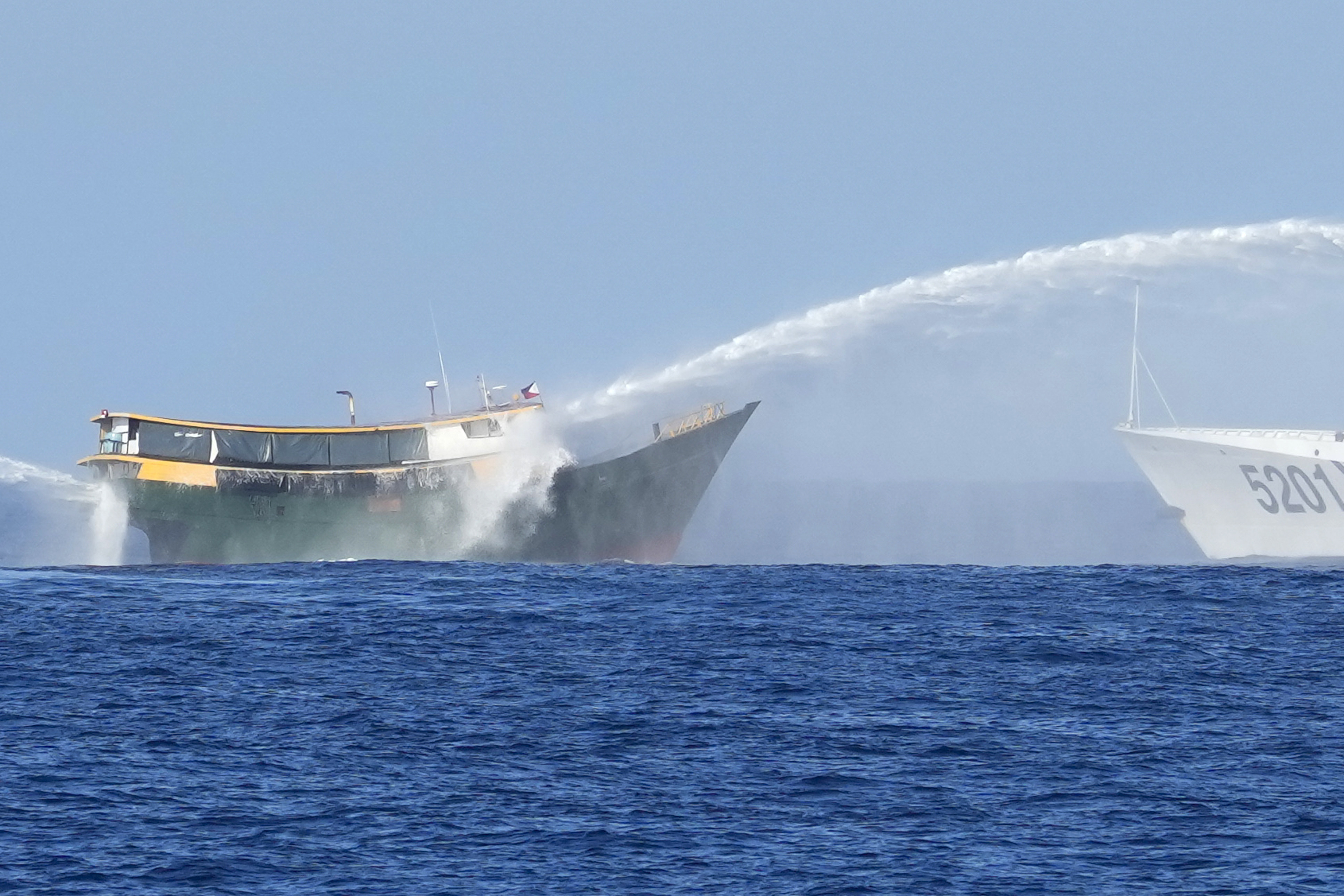 A Philippine resupply ship is hit by water cannons as it tries to enter the Second Thomas Shoal in the South China Sea on March 5. Photo: AP