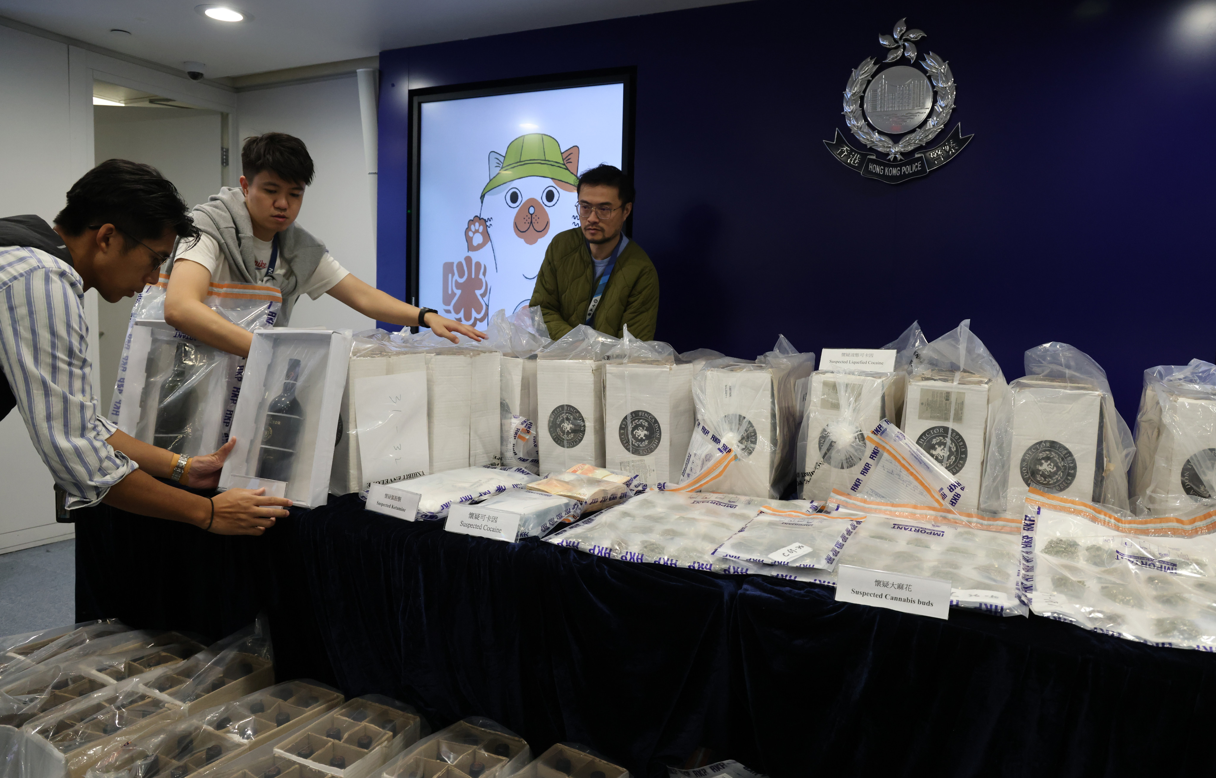 A Hong Kong police narcotics bureau press conference displays illegal drugs seized during an investigation, including 214 kilograms of suspected liquid cocaine, one kilogram of suspected cocaine, a small amount of cracked cocaine and other illegal drugs valued at about $215 million. Photo: Jelly Tse