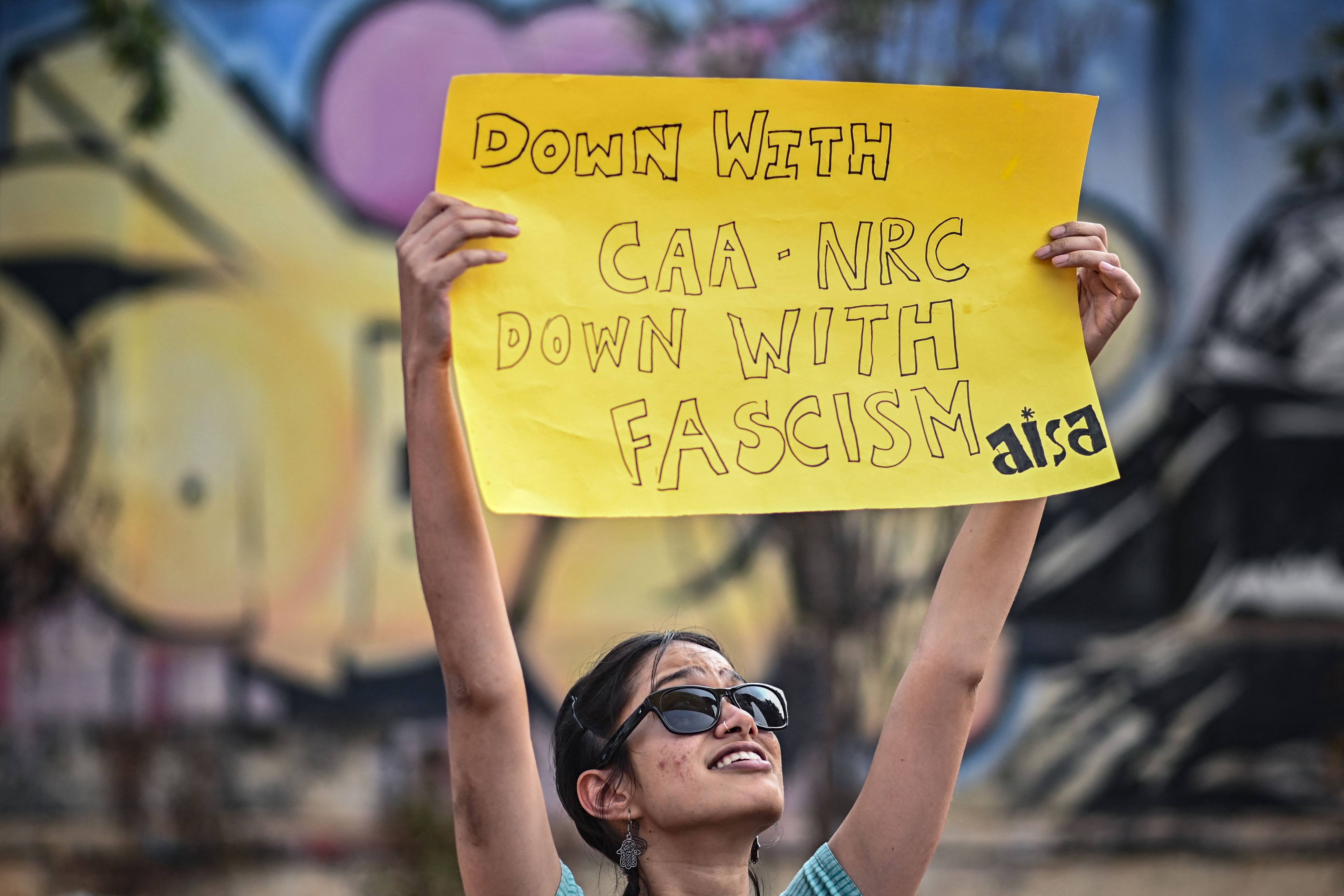 An activist holds a placard during a protest against the implementation of the Citizenship Amendment Act in Bengaluru, India, on March 13. Photo: AFP