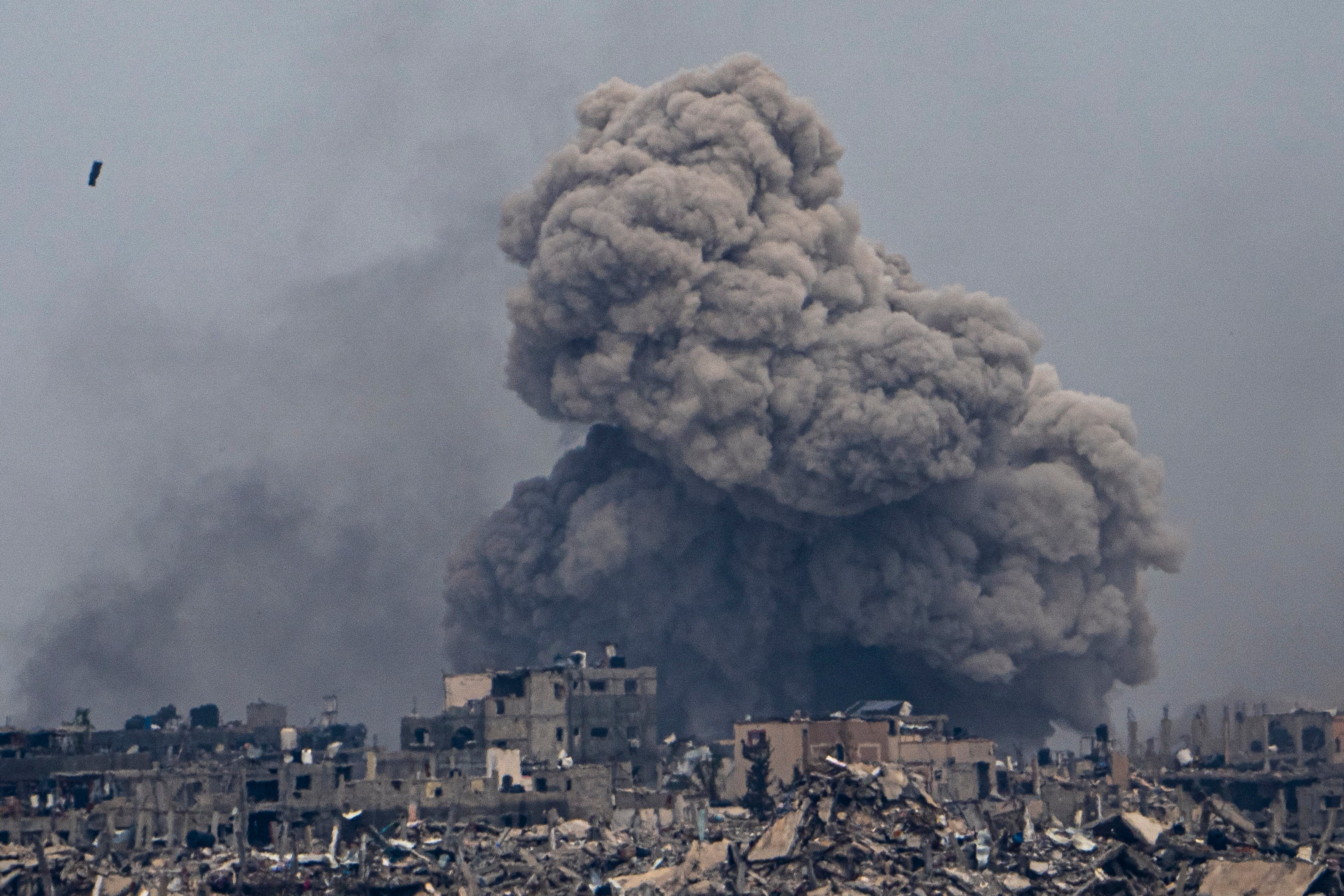 Smoke and explosions rise inside the Gaza Strip, as seen from southern Israel, on Sunday. Photo: AP