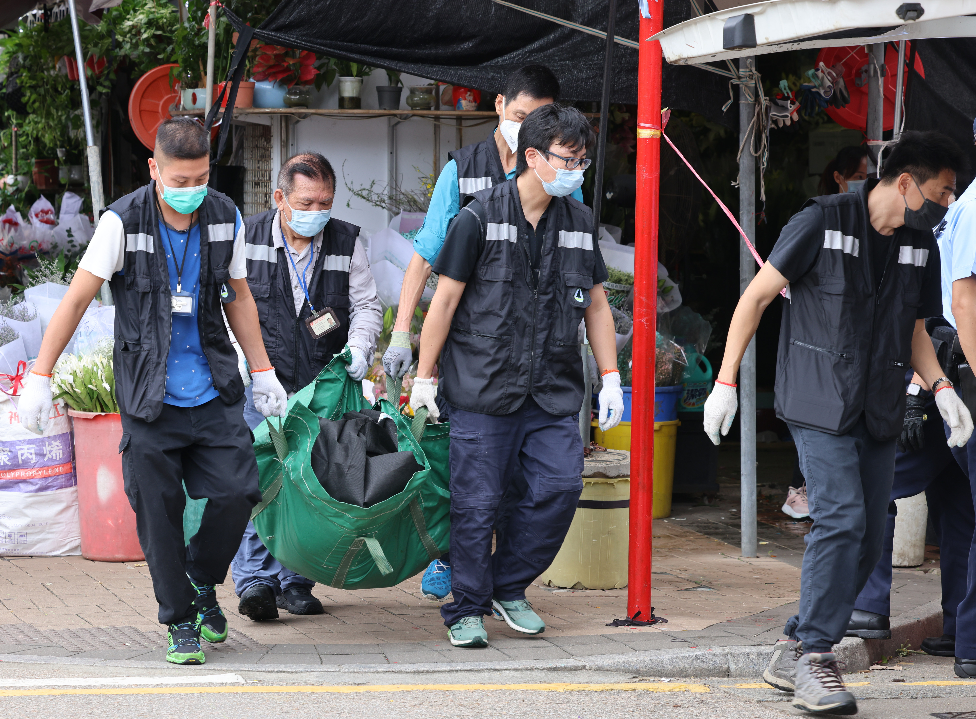 Police and Agriculture, Fisheries and Conservation Department representatives are seen in Mong Kok flower market after a wild boar mauled a shop worker in October 2023. Photo: Dickson Lee