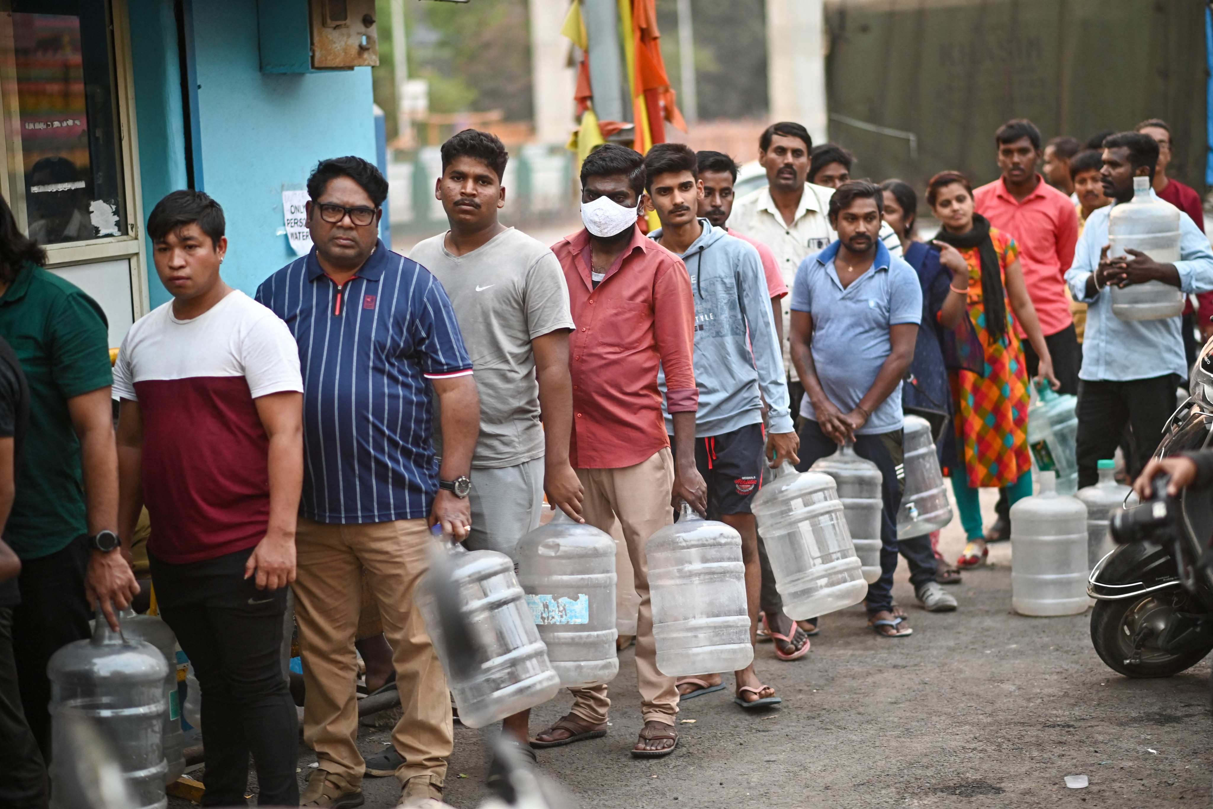 Residents of Bengaluru queue to collect drinking water on Thursday amid the city’s ongoing water crisis. Photo: AFP