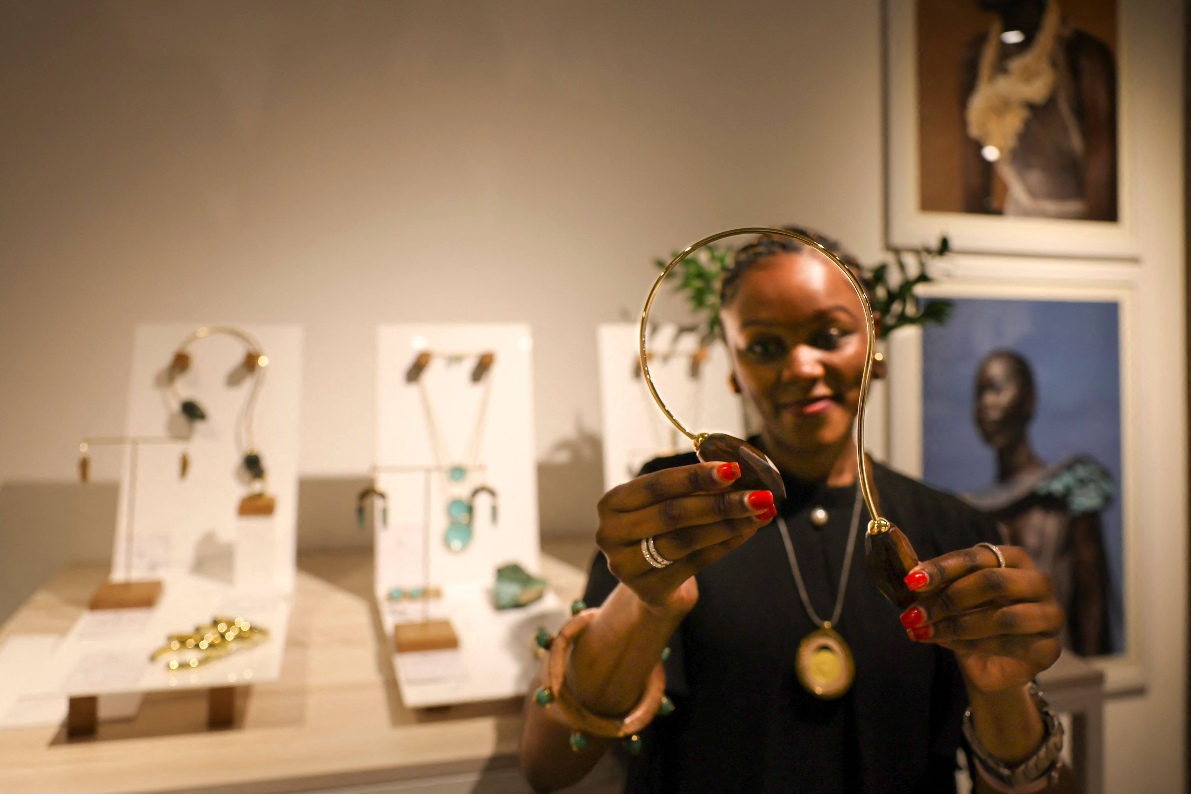 A staff member displays neck piece jewellery from a display of Kenyan designer Ami Doshi Shah’s handcrafted designs. Photo: AFP