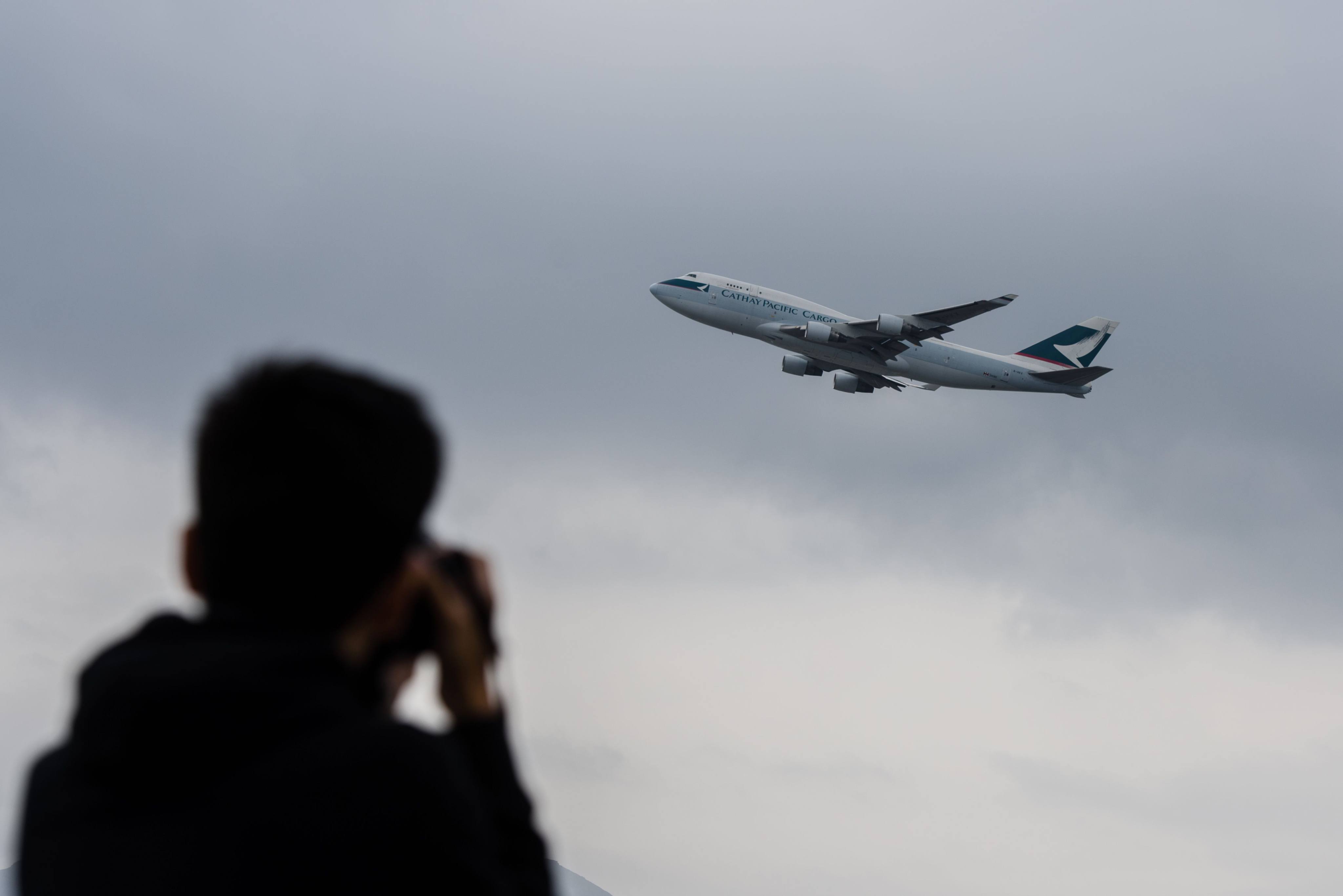 A plane spotter photographs a Cathay Pacific cargo aircraft as it takes off from Hong Kong International Airport. Aircraft enthusiasts from the city and beyond talk about the best ways to watch airliners in action. Photo: AFP