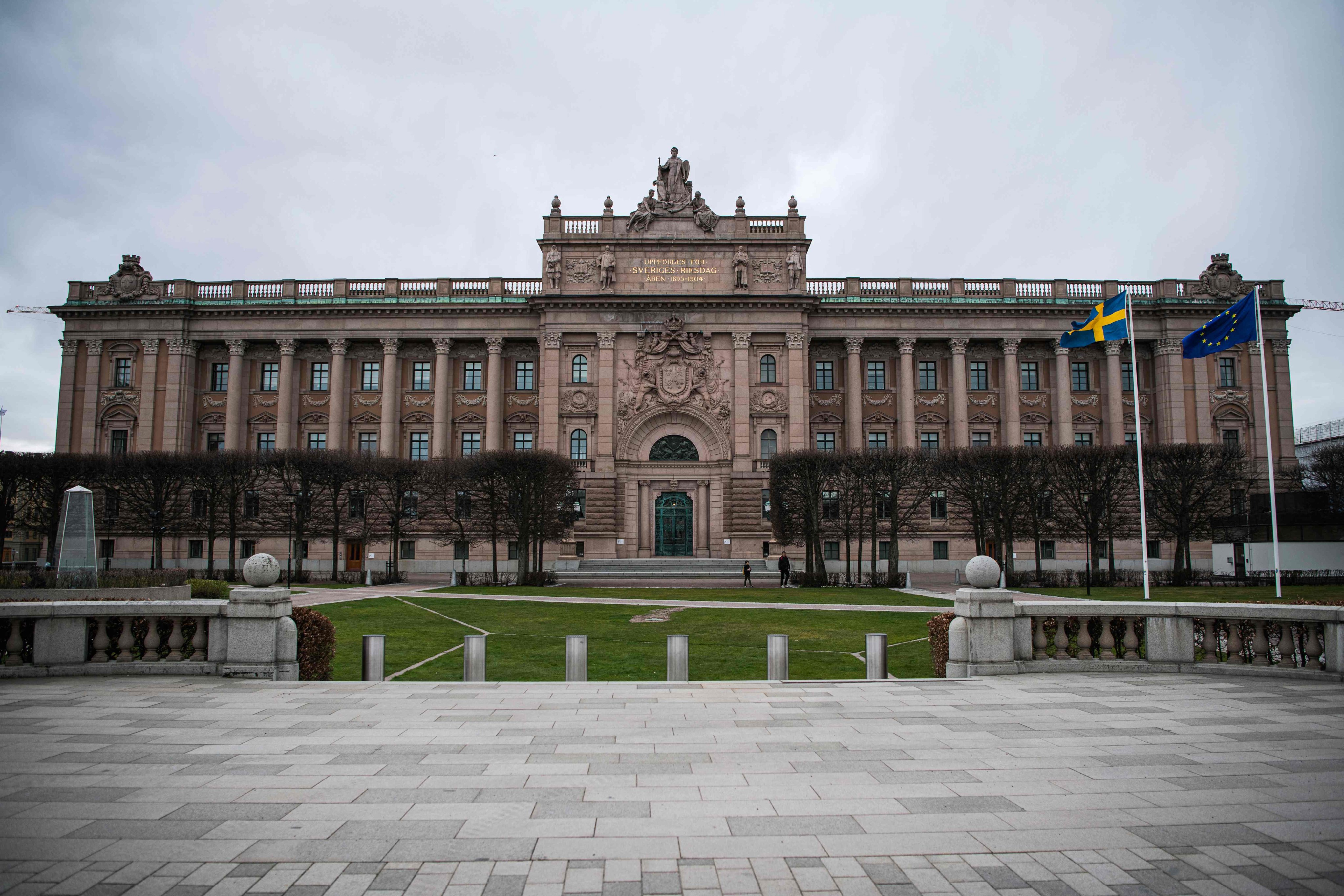 The Swedish and EU flags fly in front of the Swedish Parliament in Stockholm. Two Afghans linked to the Islamic State group were arrested in Germany on suspicion of planning an attack around Sweden’s parliament in retaliation for Koran burnings, prosecutors said. Photo: AFP