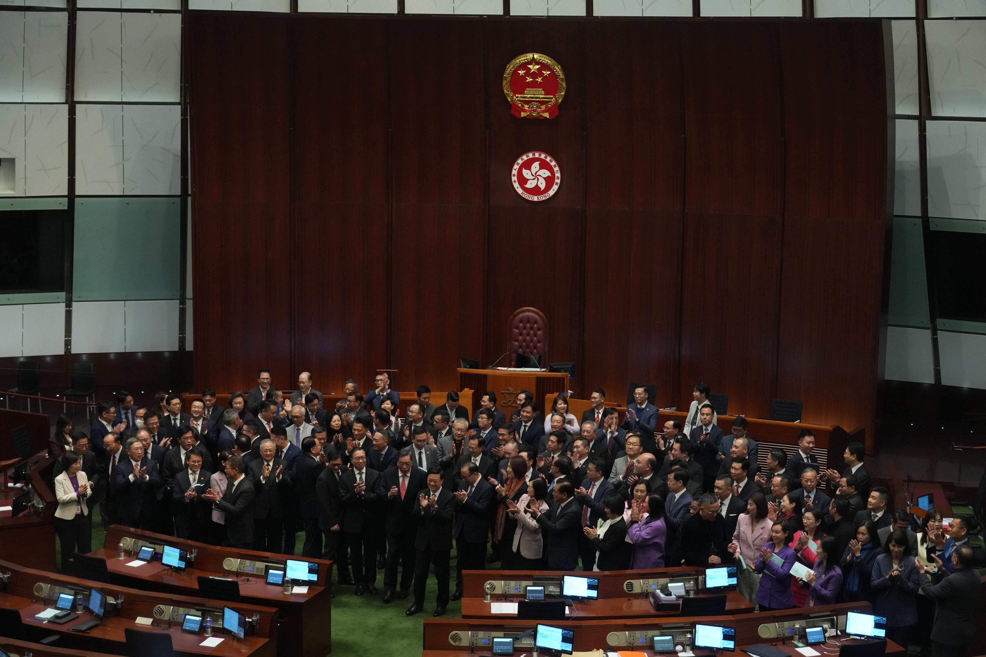 Legislators and the chief executive pose for photos after the historic passing of the Article 23 bill. The new law spans 39 offences divided into five categories. Photo: Sam Tsang