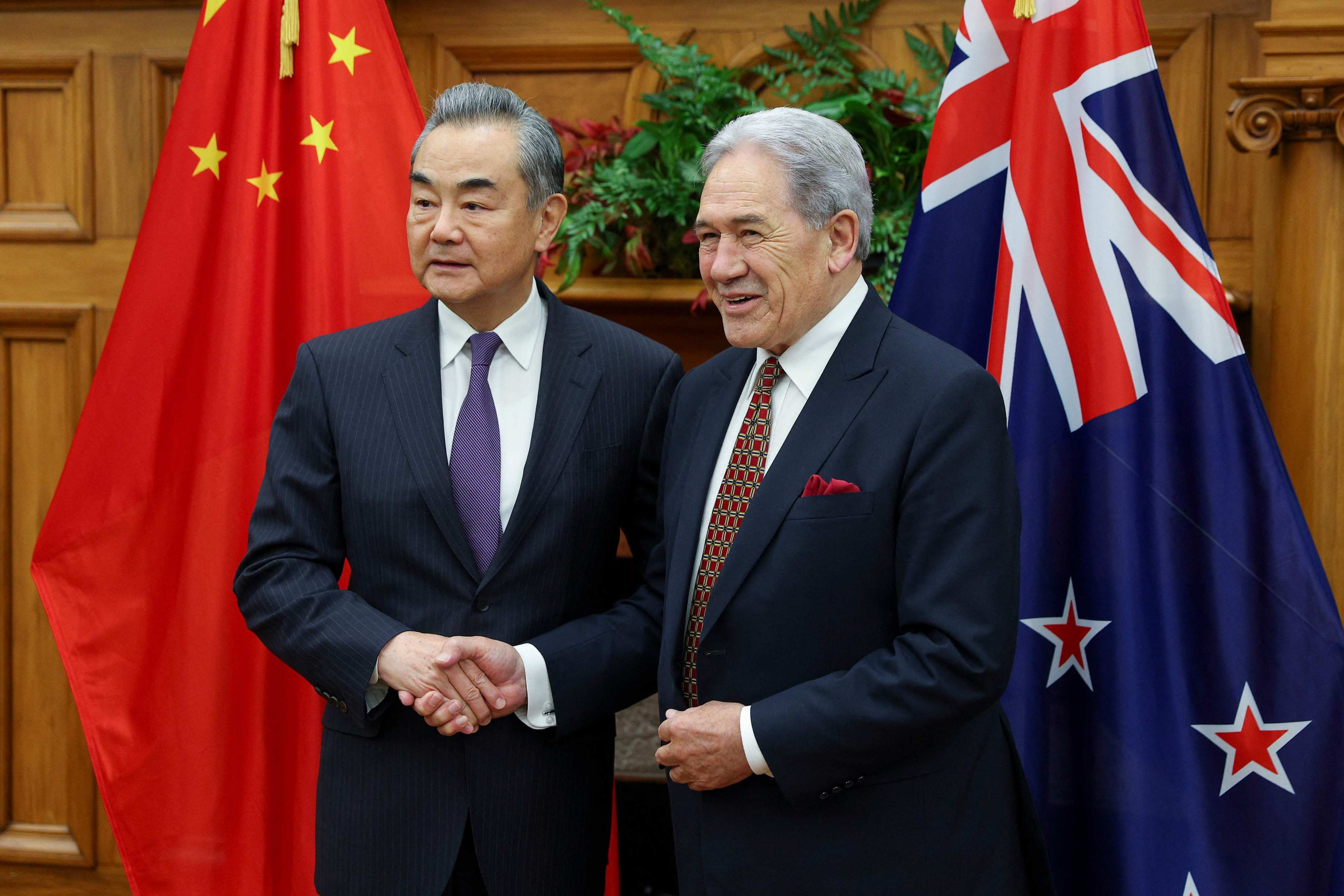 New Zealand’s Minister of Foreign Affairs Winston Peters (right) shakes hands with China’s Foreign Minister Wang Yi during a bilateral meeting at Parliament in Wellington on Monday. Photo: AFP