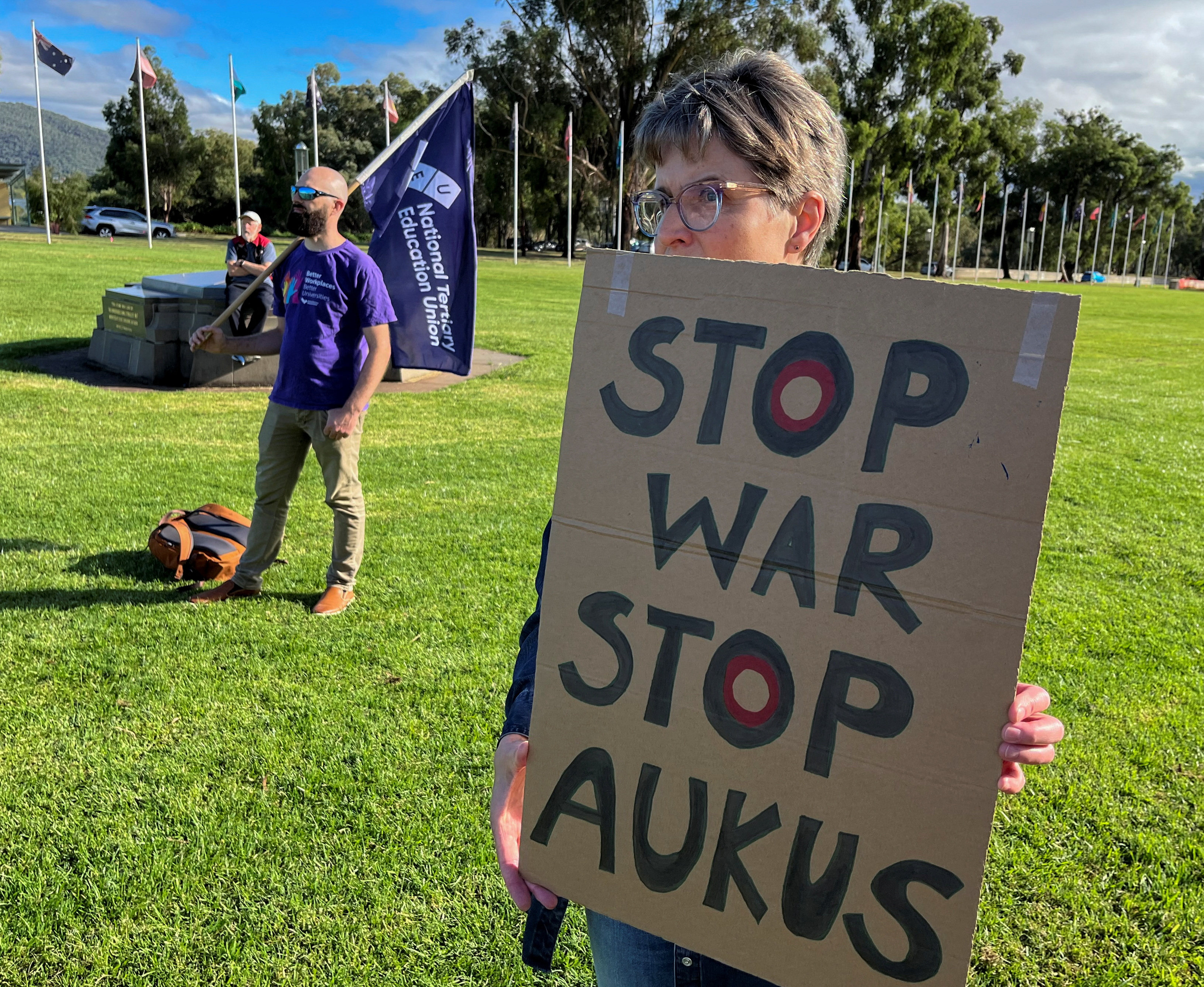 Anti-Aukus protesters stand outside Australia’s parliament in Canberra on Monday. Photo: Reuters