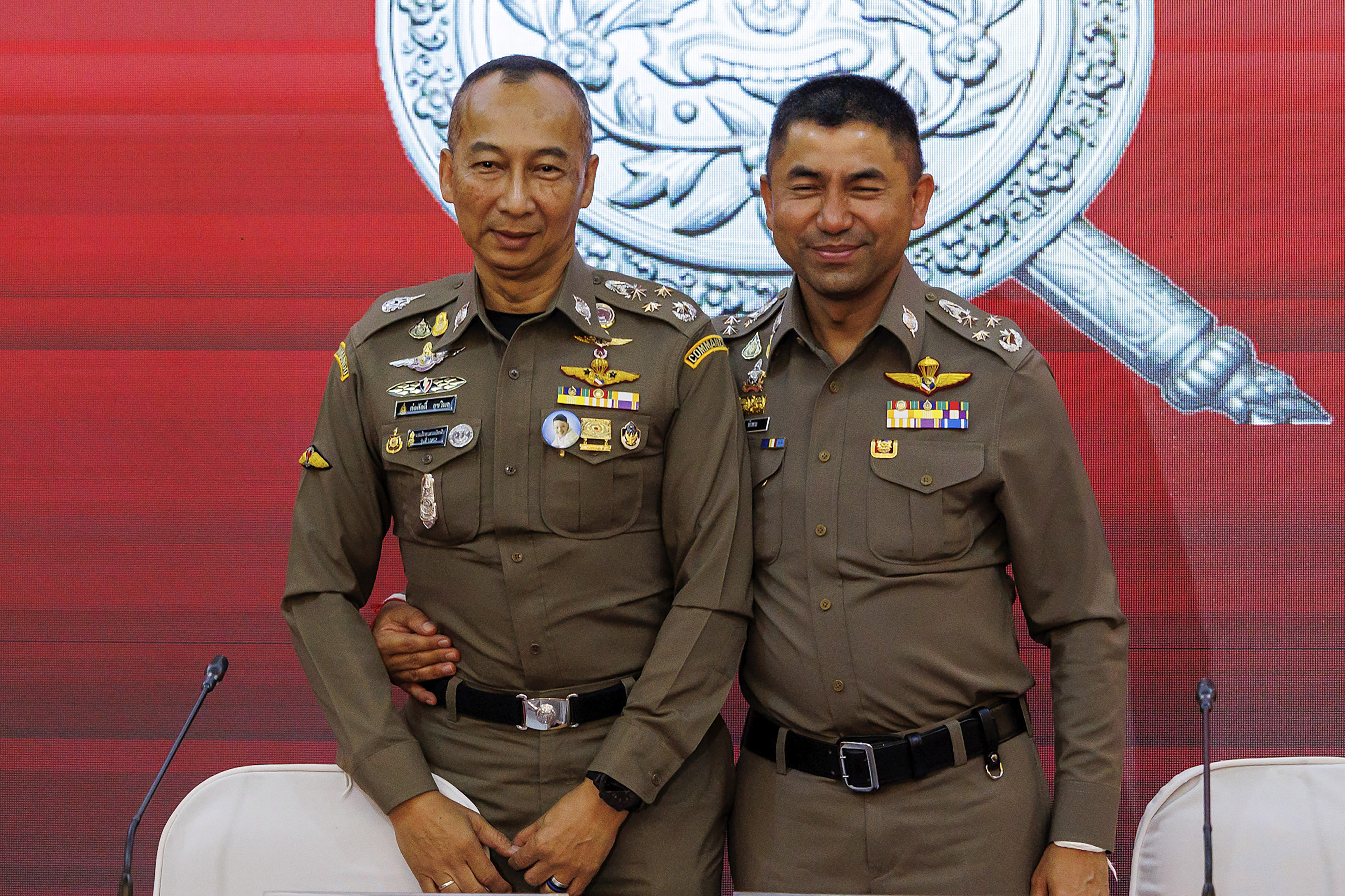 Chief Royal Thai Police Torsak Sukvimol (left) and Duputy Chief the royal Thai Police Surachate Hakparn embrace after a press conference in Bangkok. Thailand’s national police chief and a deputy were ordered to be suspended by the Prime Minister on Wednesday, following a feud that escalated over the past few weeks, pointing to serious conflicts within the highest echelons of the police department. Photo: AP
