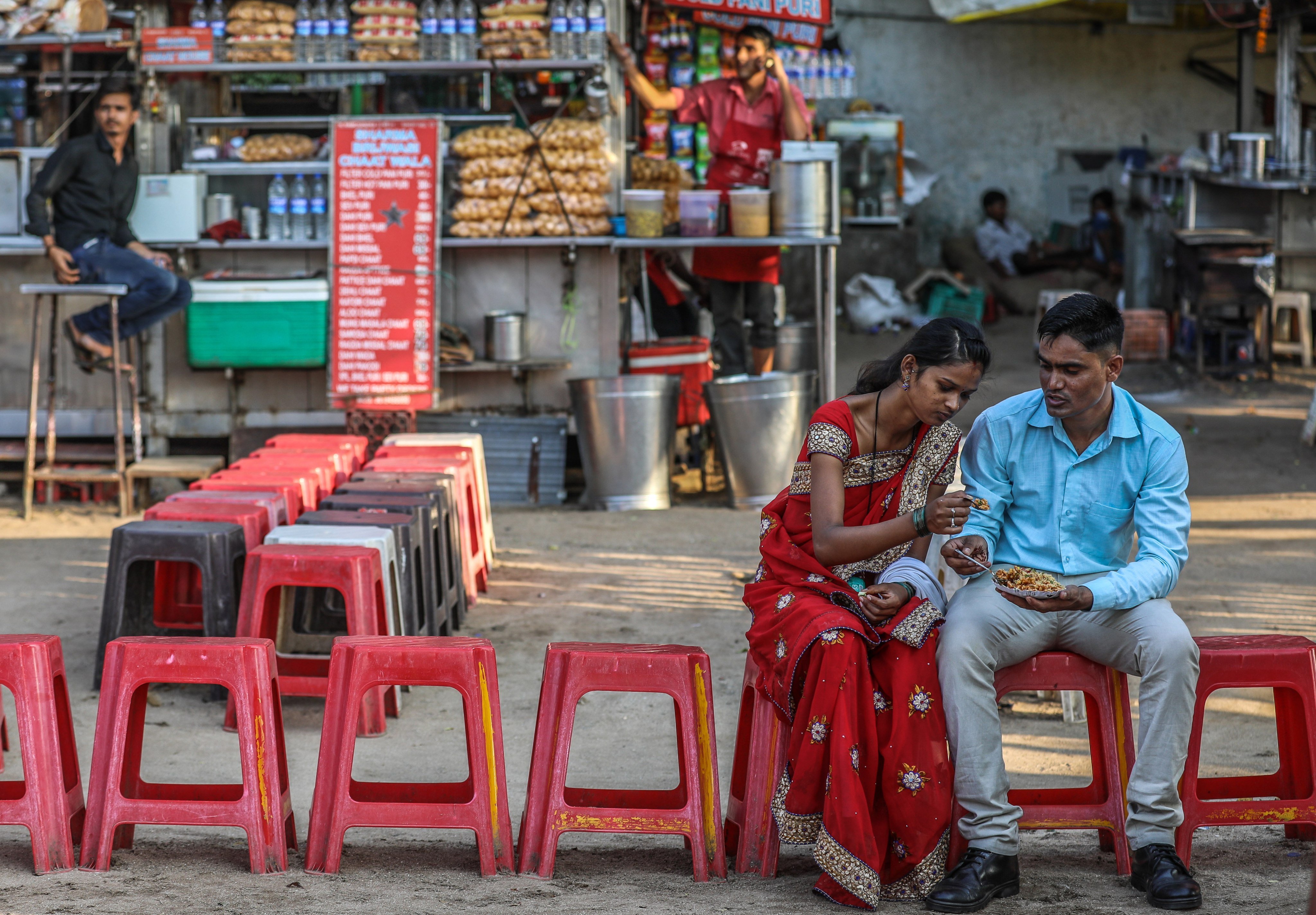 An Indian couple enjoys some street food in Mumbai. Official data shows the total fertility rate in India has dropped 20 per cent in the last 10 years to below replacement levels. Photo: EPA-EFE