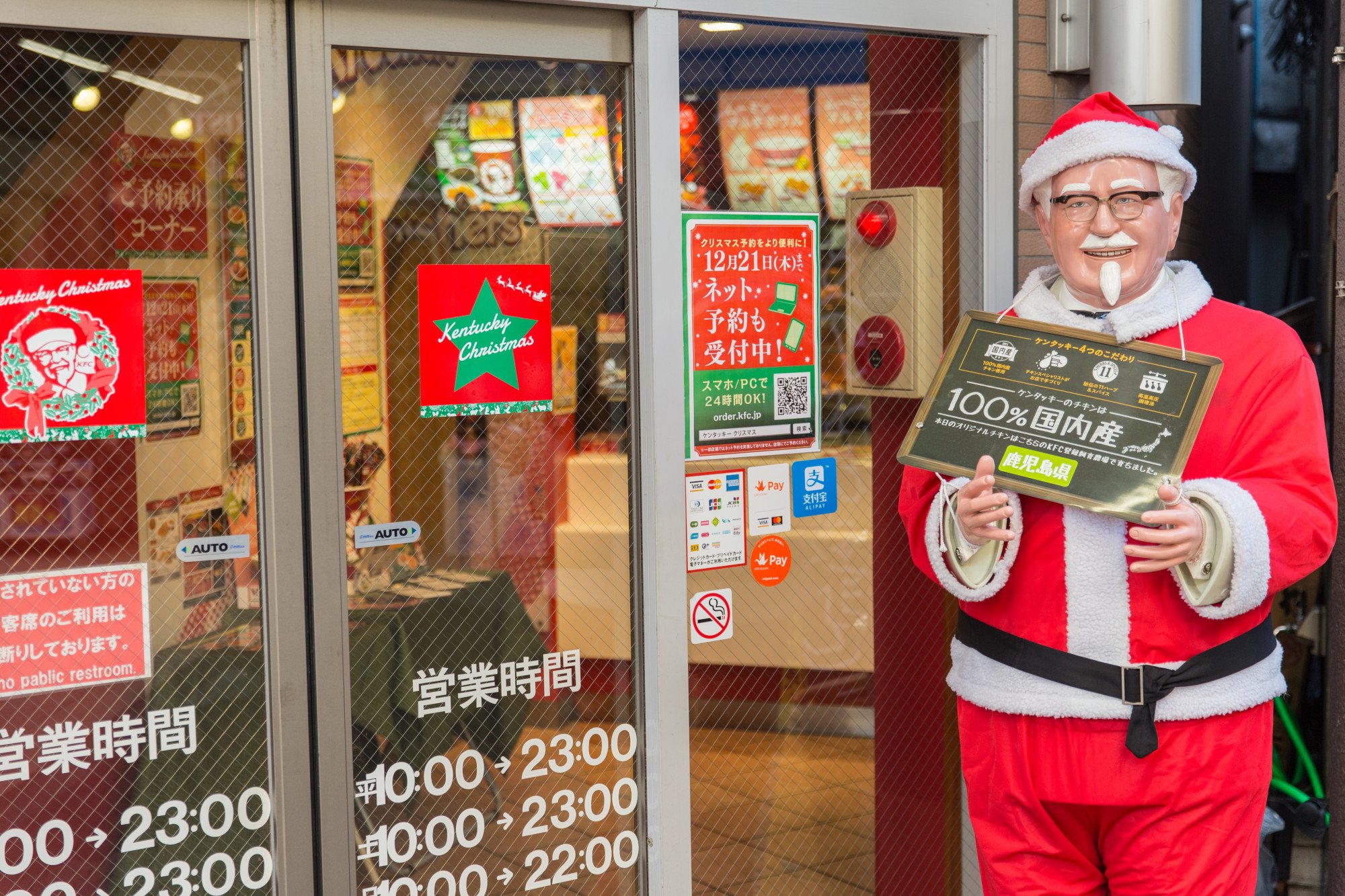 A statue of KFC founder Colonel Sanders dressed up for Christmas in front of one of the fast food chain’s outlets in Japan. Photo: Shutterstock