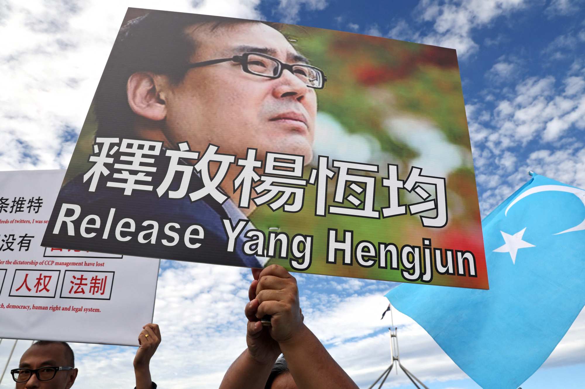 Protesters hold placards demanding the release of Australian academic Yang Hengjun during a rally outside Parliament House in Canberra, Australia, on Wednesday. Photo: AFP