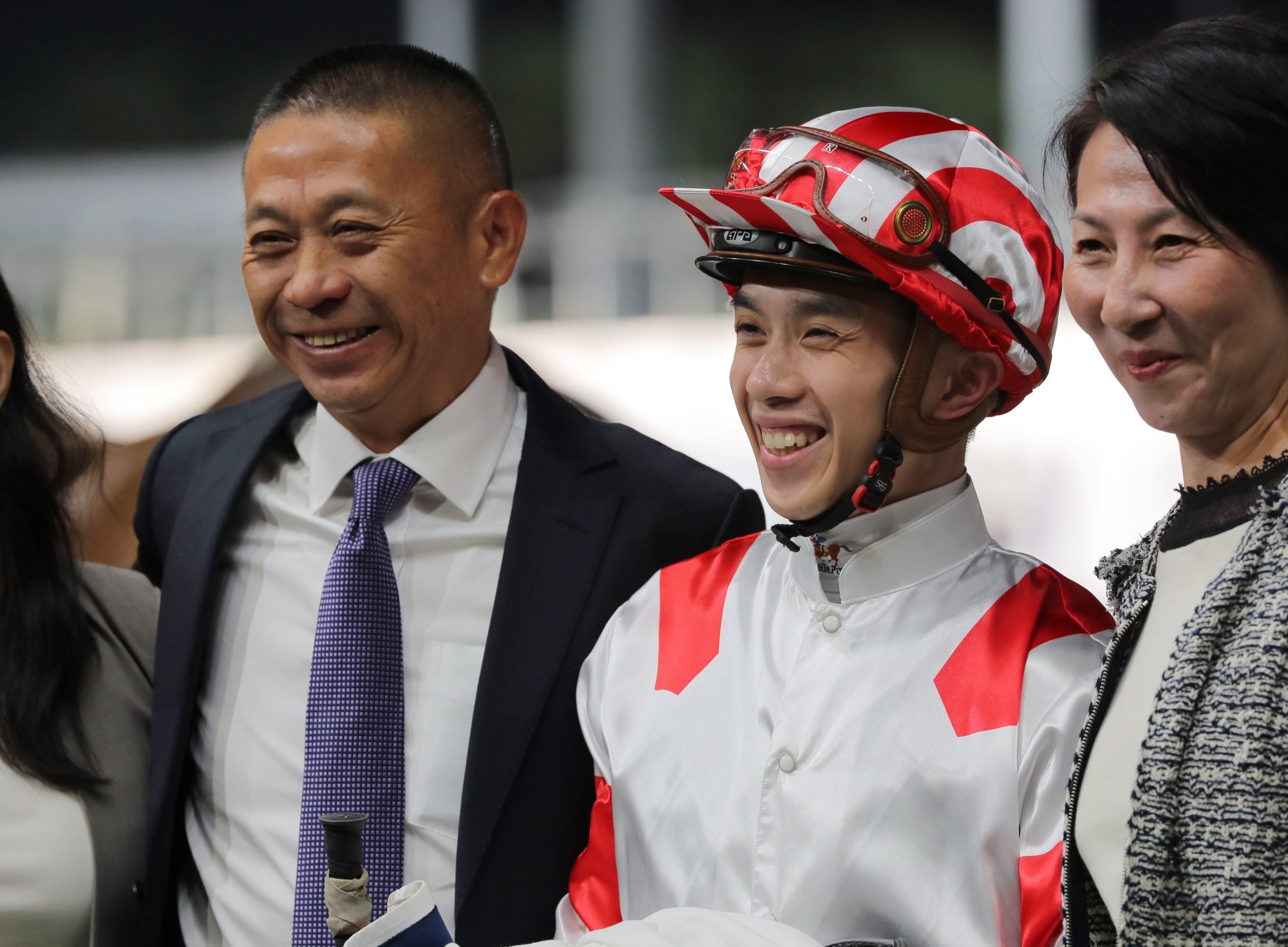 Trainer Danny Shum celebrates Sports Legend’s win with apprentice jockey Angus Chung and connections.