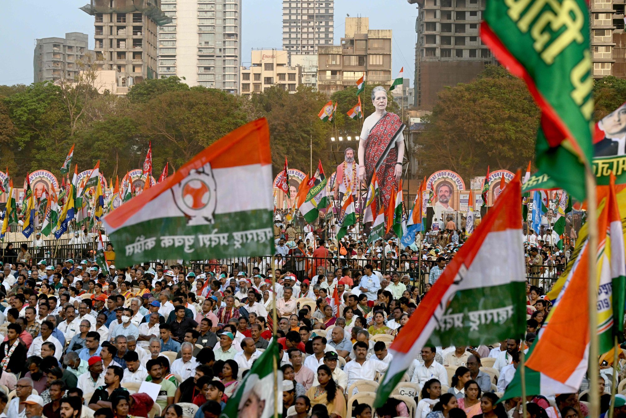 Large cutouts of India’s Congress party leaders Sonia Gandhi and her son Rahul Gandhi are carried by supporters during a campaign rally in Mumbai on March 17. Photo: AFP
