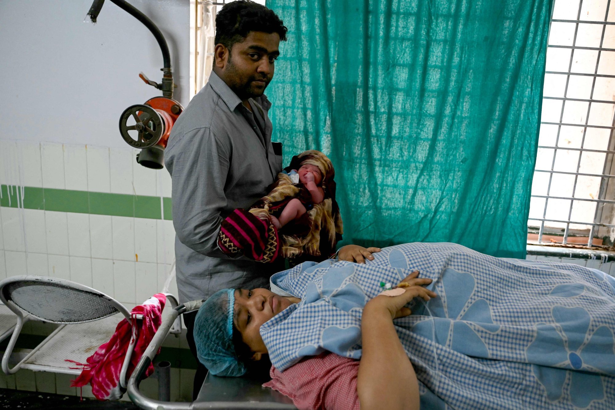A couple tends to their newborn baby at a maternity ward in a government hospital in Hyderabad on February 29. Photo: AFP