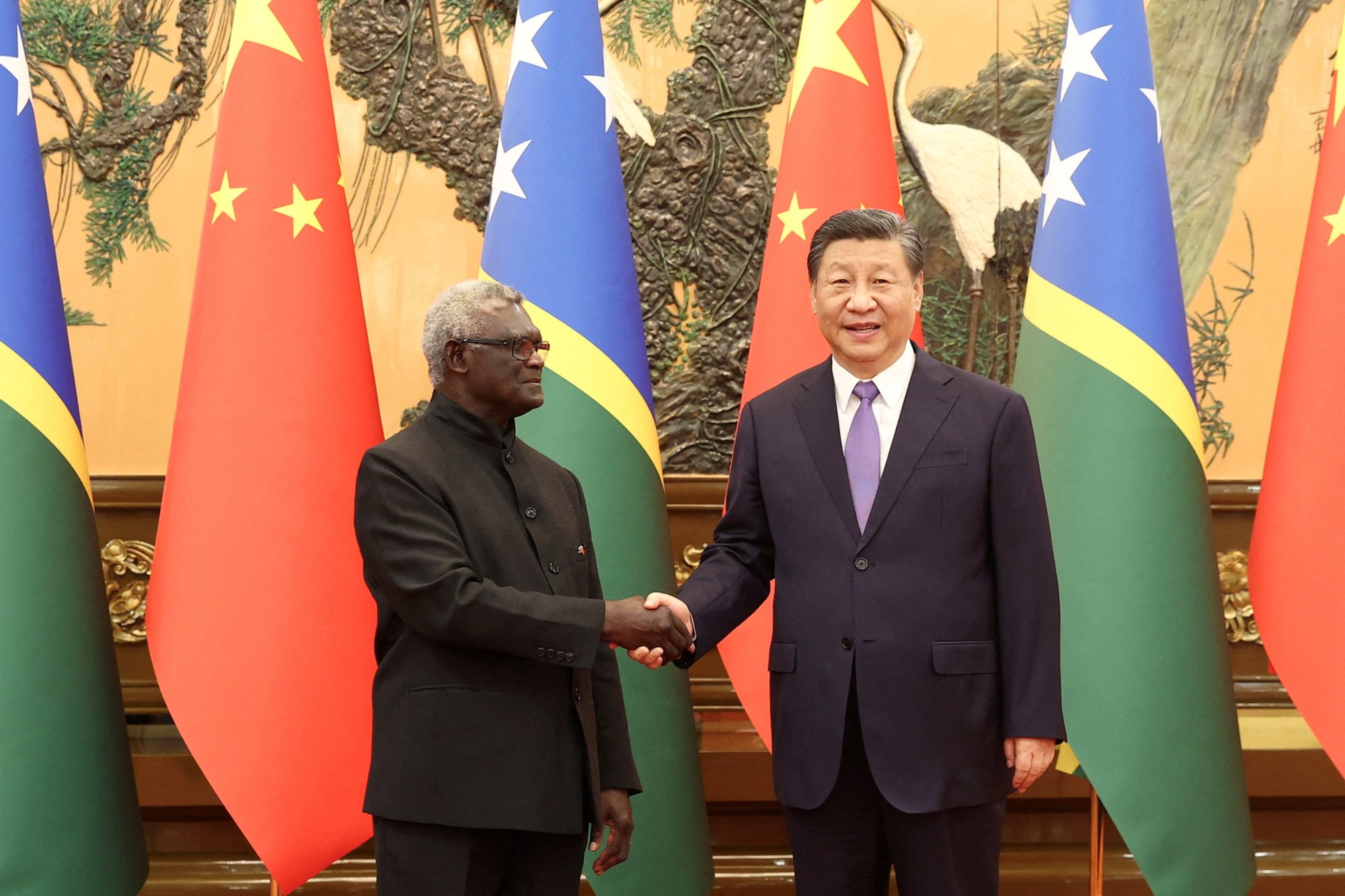 Chinese President Xi Jinping and Solomon Islands Prime Minister Manasseh Sogavare shake hands at the Great Hall of the People in Beijing, China July 10, 2023. Photo: Handout via Reuters