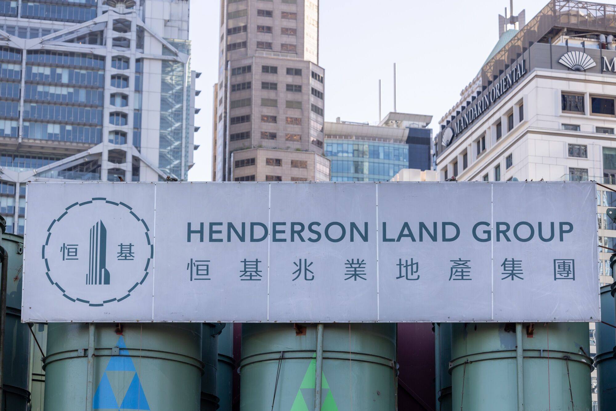 Signage for Henderson Land is seen at a construction site in Hong Kong. Photo: Bloomberg
