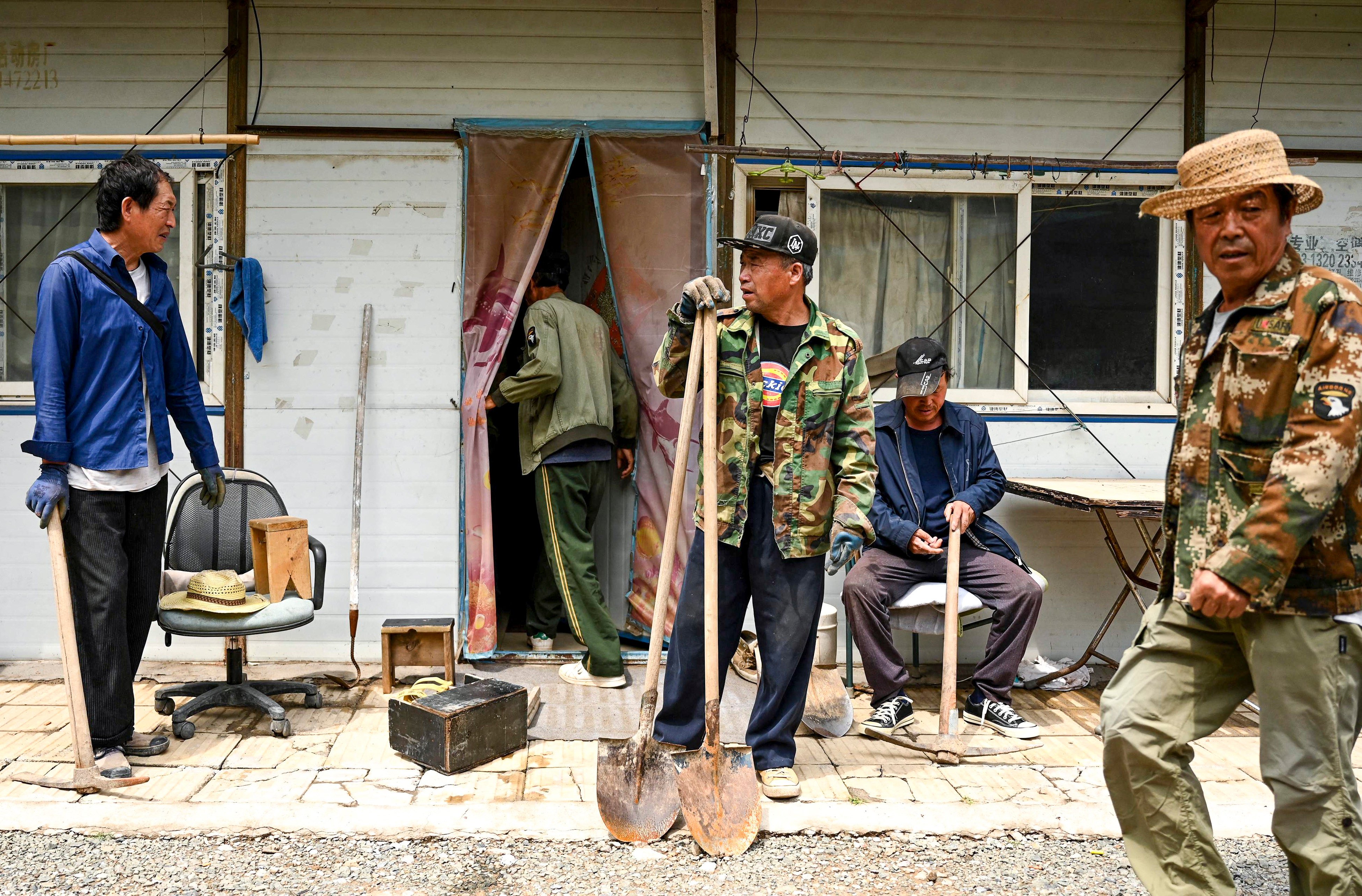 Migrant workers outside their living quarters in Beijing’s middle-class neighbourhood of Shangdi. Photo: AFP