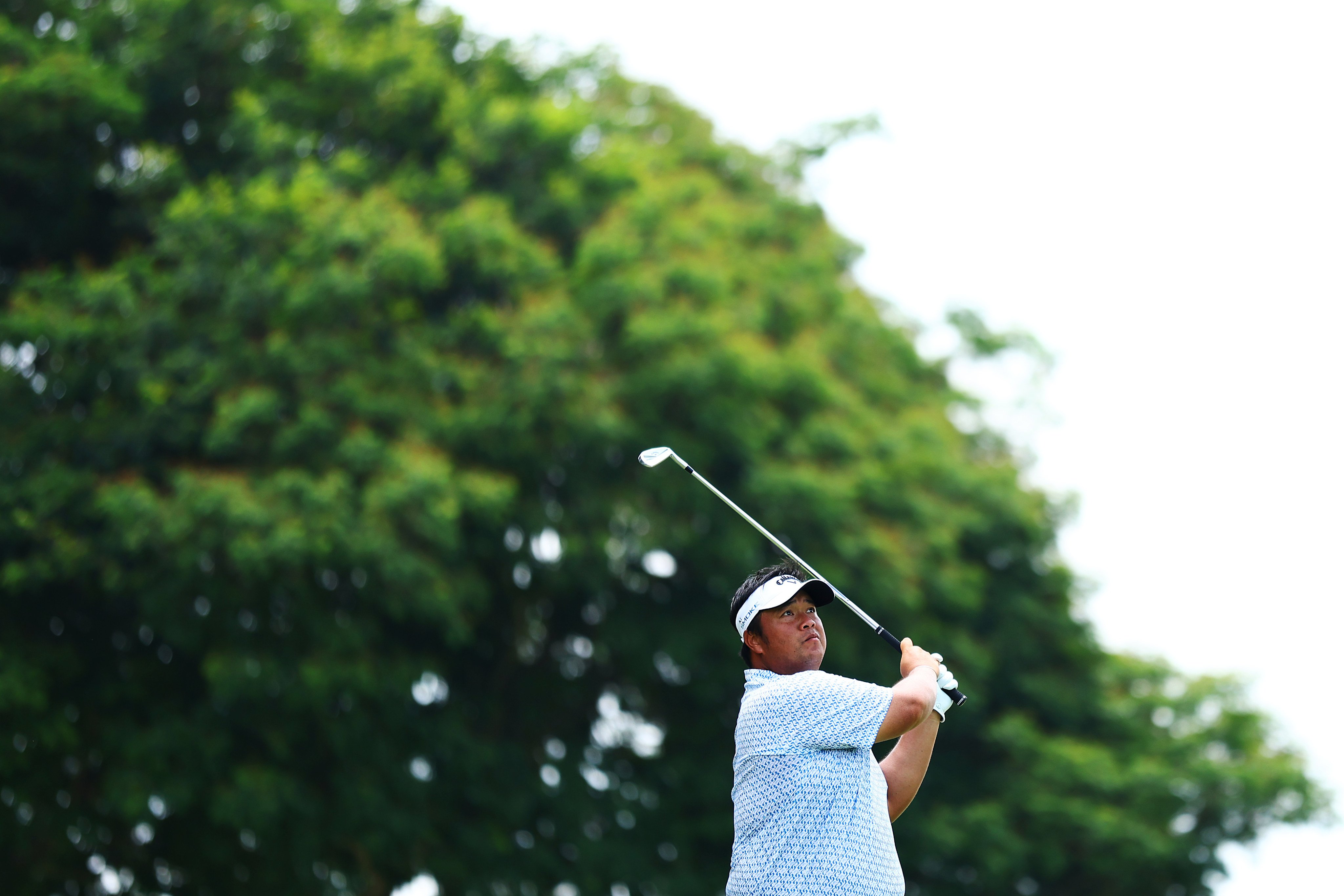 Kiradech Aphibarnrat of Thailand tees off on the par-3 seventh during the first round of the Porsche Singapore Classic at Laguna National Golf Resort Club. Photo: Getty Images