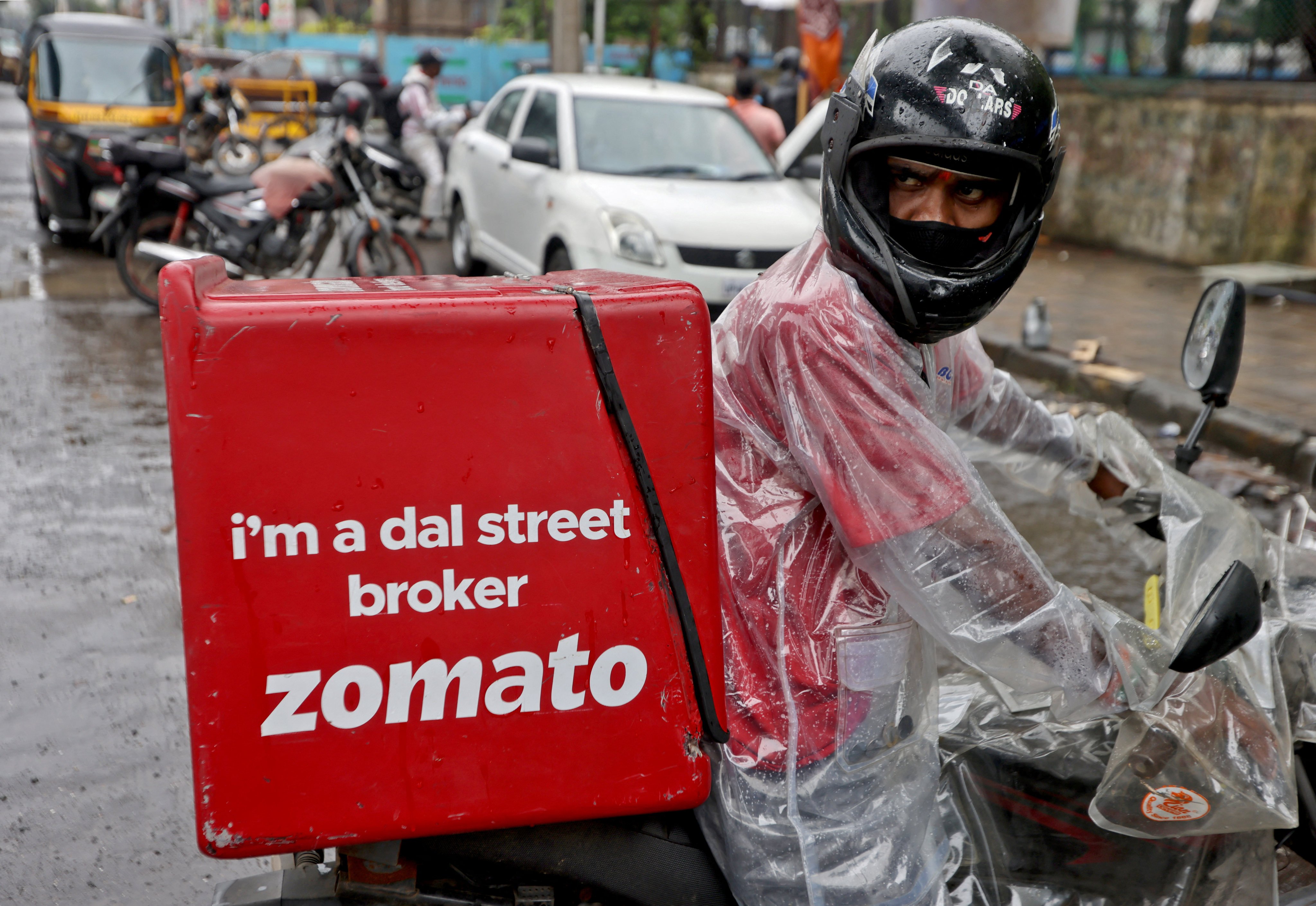 A delivery worker of Zomato, an Indian food-delivery startup, prepares to pick up an order from a restaurant in Mumbai. Photo: Reuters